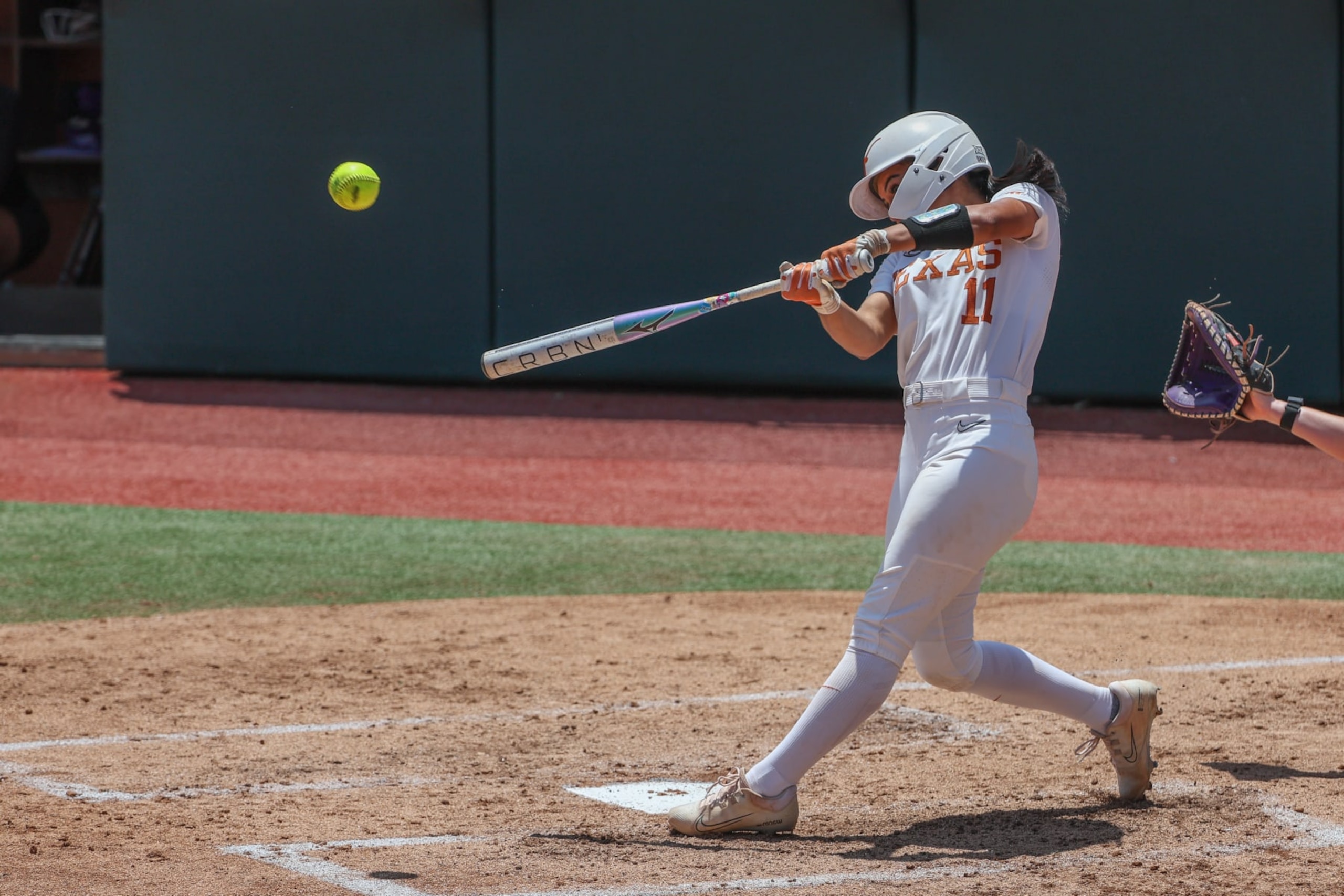 AUSTIN, TX - MAY 18: Texas infielder Alyssa Washington (11) hits a two run home run during the NCAA Division I Regional game between Texas Longhorns and Northwestern Wildcats on May 18, 2024, at Red & Charline McCombs Field in Austin, TX. (Photo by David Buono/Icon Sportswire via Getty Images)