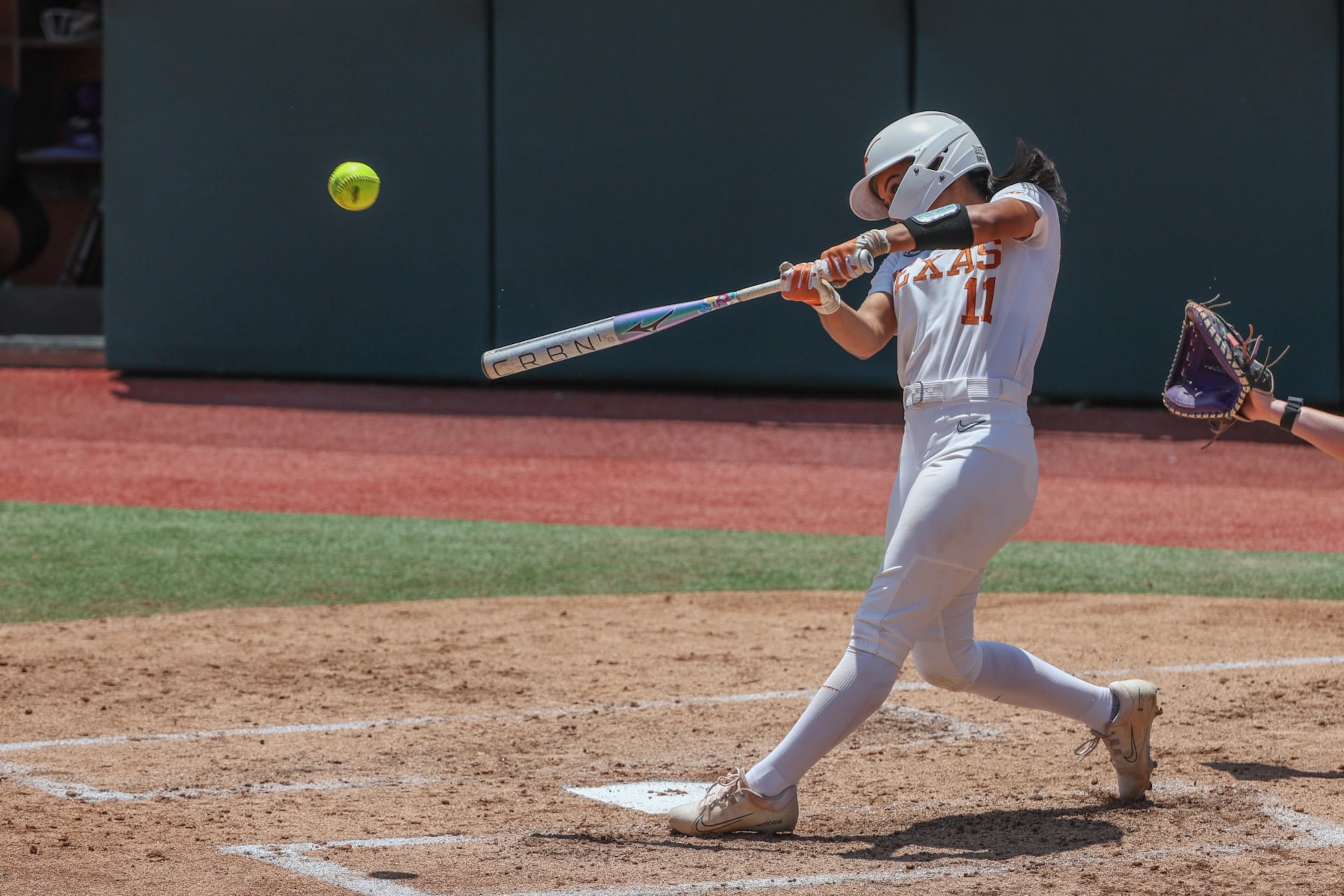 AUSTIN, TX - MAY 18: Texas infielder Alyssa Washington (11) hits a two run home run during the NCAA Division I Regional game between Texas Longhorns and Northwestern Wildcats on May 18, 2024, at Red & Charline McCombs Field in Austin, TX. (Photo by David Buono/Icon Sportswire via Getty Images)