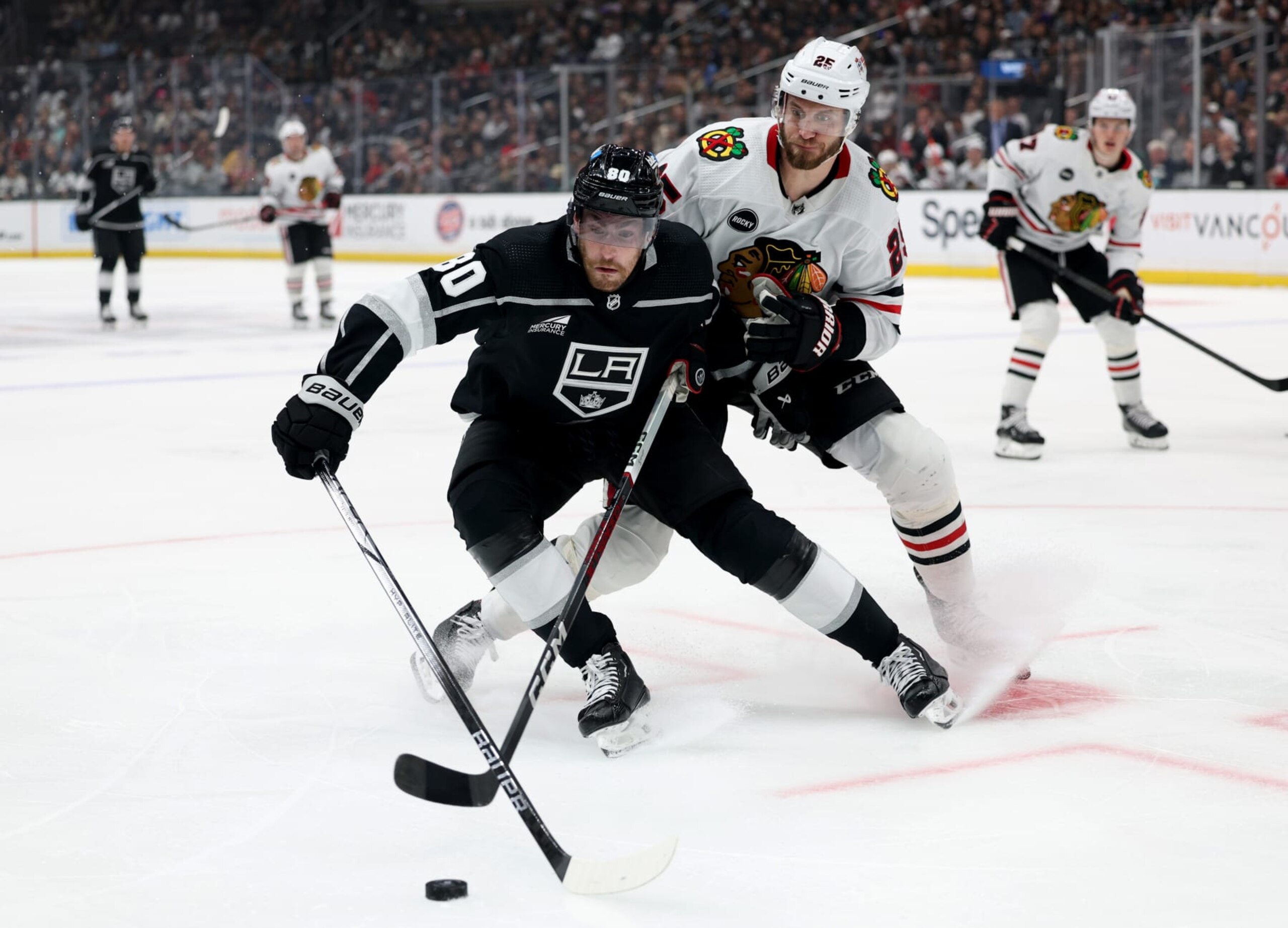 LOS ANGELES, CALIFORNIA - APRIL 18: Pierre-Luc Dubois #80 of the Los Angeles Kings turns for the puck in front of Jarred Tinordi #25 of the Chicago Blackhawks during the second period at Crypto.com Arena on April 18, 2024 in Los Angeles, California. (Photo by Harry How/Getty Images)