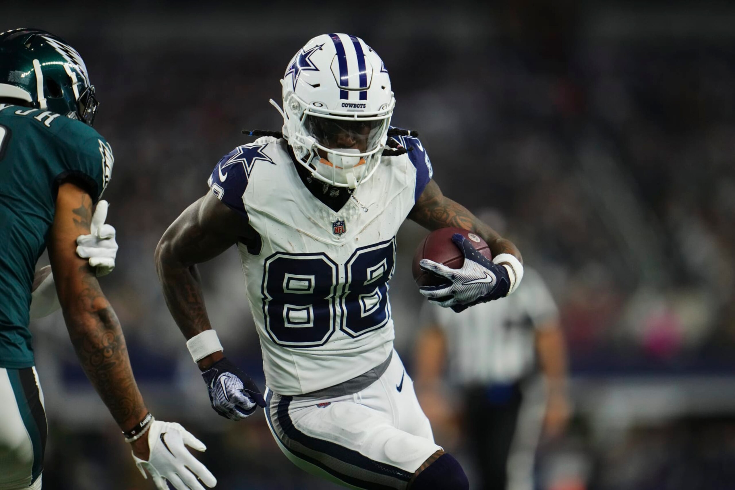 ARLINGTON, TX - DECEMBER 10: CeeDee Lamb #88 of the Dallas Cowboys runs with the ball against the Philadelphia Eagles during the first half at AT&T Stadium on December 10, 2023 in Arlington, Texas. (Photo by Cooper Neill/Getty Images)
