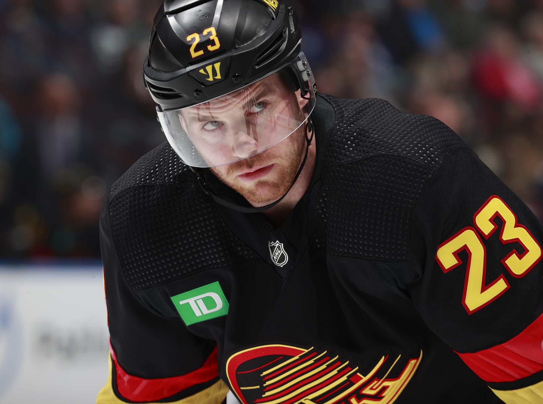 VANCOUVER, CANADA - APRIL 10: Elias Lindholm #23 of the Vancouver Canucks lines up for a face off during their NHL game against the Arizona Coyotes at Rogers Arena on April 10, 2024 in Vancouver, British Columbia, Canada.  (Photo by Jeff Vinnick/NHLI via Getty Images)