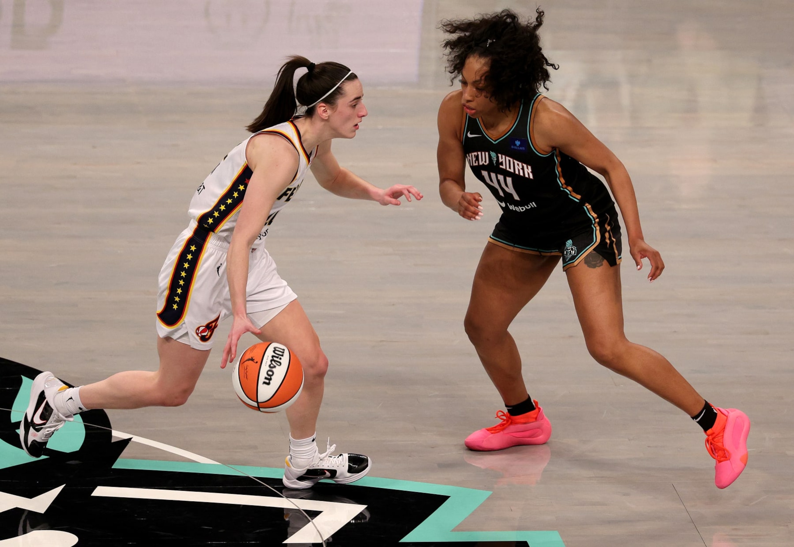 NEW YORK, NEW YORK - MAY 18: Caitlin Clark #22 of the Indiana Fever tries to get past Betnijah Laney-Hamilton #44 of the New York Liberty during the first half at Barclays Center on May 18, 2024 in New York City. NOTE TO USER: User expressly acknowledges and agrees that, by downloading and or using this photograph, User is consenting to the terms and conditions of the Getty Images License Agreement. (Photo by Elsa/Getty Images)