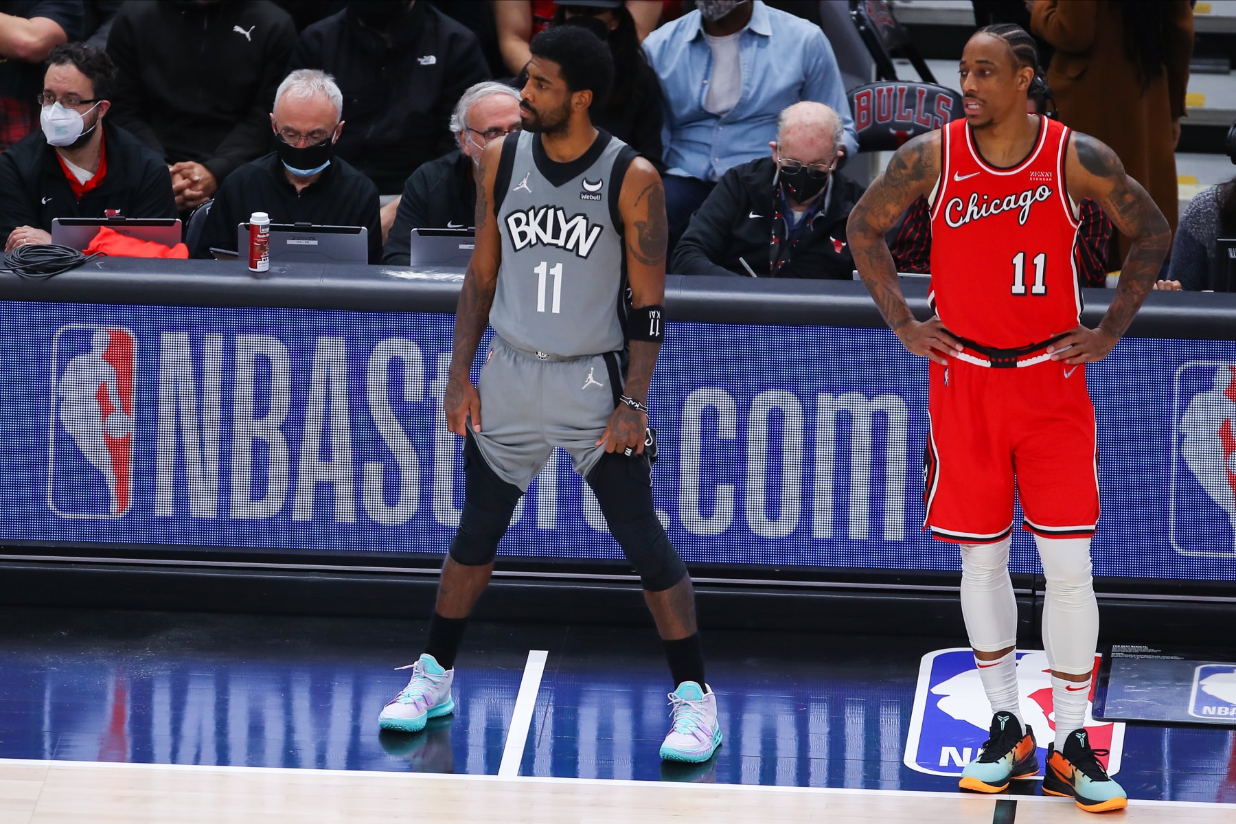 CHICAGO, IL - JANUARY 12: Brooklyn Nets Guard Kyrie Irving (11) and Chicago Bulls Forward DeMar DeRozan (11) look on before checking into the game during a NBA game between the Brooklyn Nets and the Chicago Bulls on January 12, 2022 at the United Center in Chicago, IL. (Photo by Melissa Tamez/Icon Sportswire via Getty Images)