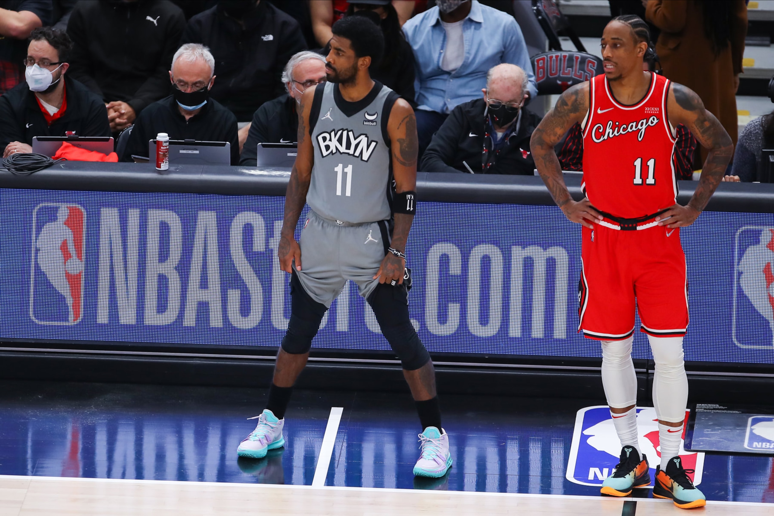 CHICAGO, IL - JANUARY 12: Brooklyn Nets Guard Kyrie Irving (11) and Chicago Bulls Forward DeMar DeRozan (11) look on before checking into the game during a NBA game between the Brooklyn Nets and the Chicago Bulls on January 12, 2022 at the United Center in Chicago, IL. (Photo by Melissa Tamez/Icon Sportswire via Getty Images)