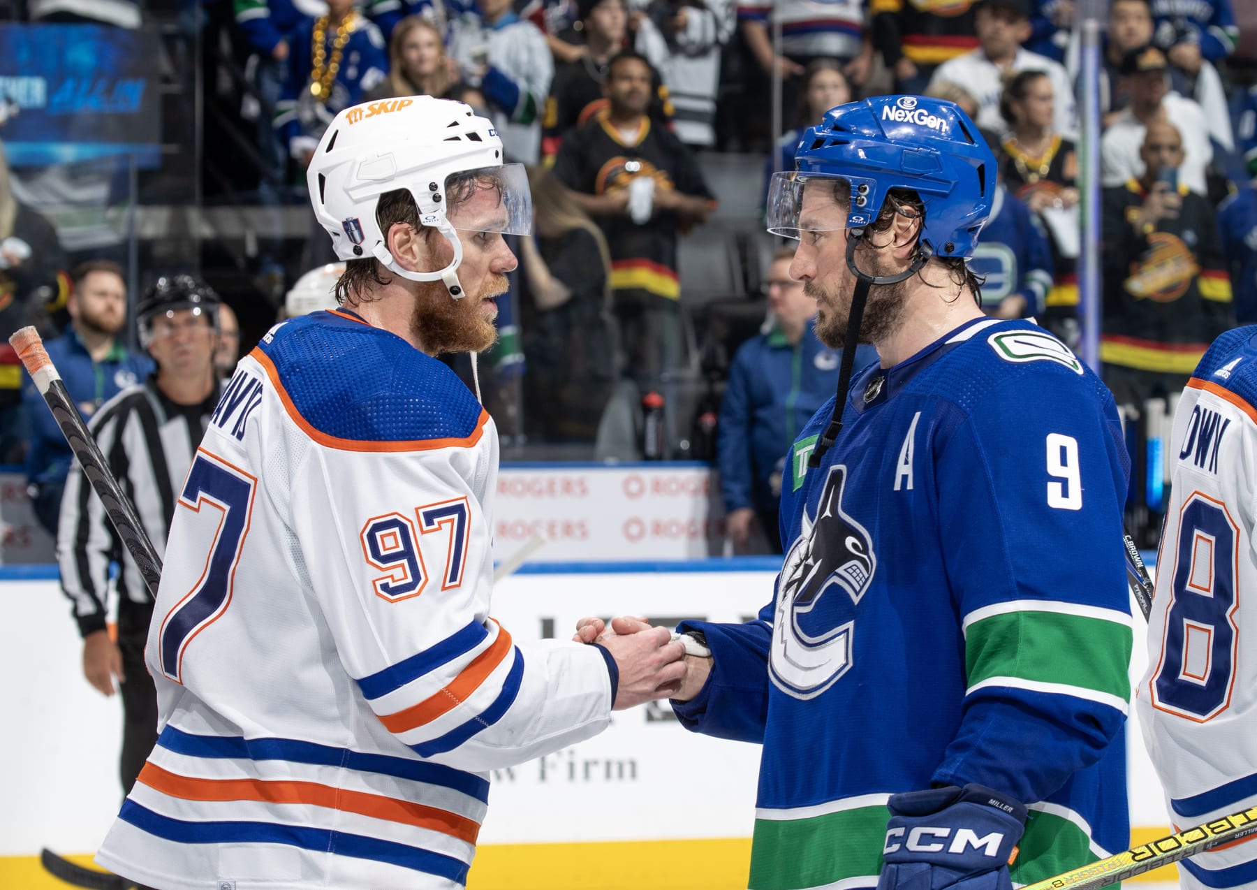 VANCOUVER, CANADA - MAY 20: J.T. Miller #9 of the Vancouver Canucks and Connor McDavid #97 of the Edmonton Oilers shake hands after Game Seven of the Second Round of the 2024 Stanley Cup Playoffs at Rogers Arena on May 20, 2024 in Vancouver, British Columbia, Canada.  Edmonton won 3-2 (Photo by Jeff Vinnick/NHLI via Getty Images)