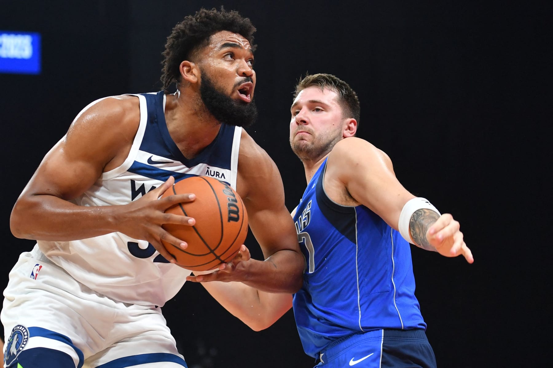 Karl-Anthony Towns, left, and Luka DonÄiÄ.