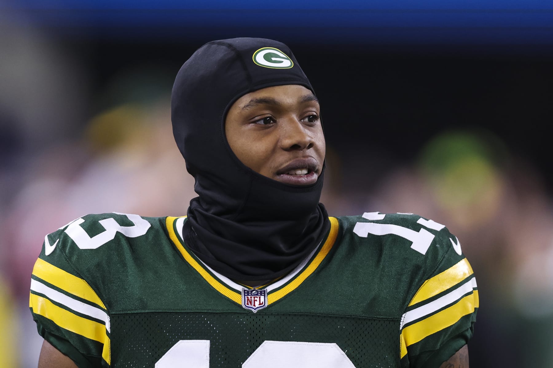 ARLINGTON, TX - JANUARY 14: Dontayvion Wicks #13 of the Green Bay Packers looks on from the sideline during an NFL wild-card playoff football game against the Dallas Cowboys at AT&T Stadium on January 14, 2024 in Arlington, Texas. (Photo by Perry Knotts/Getty Images)