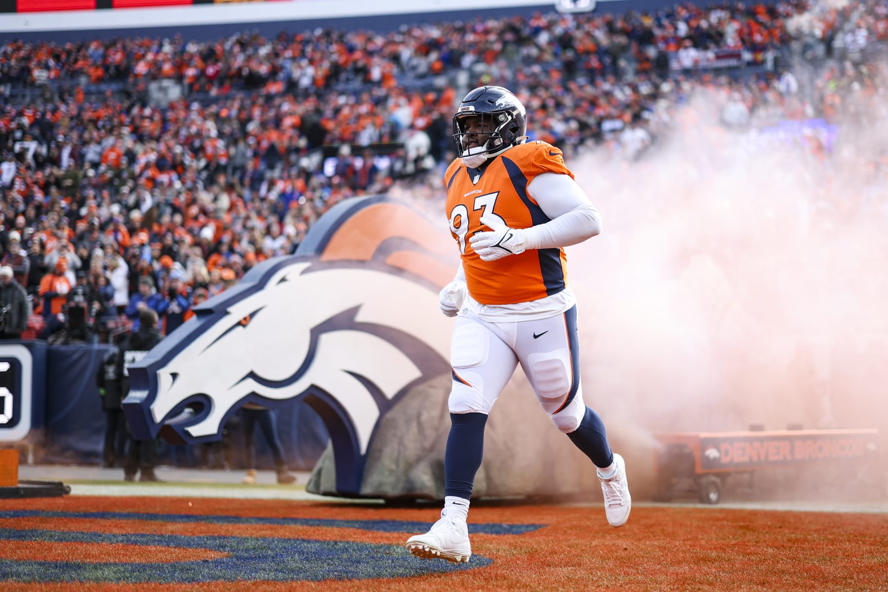 DENVER, CO - DECEMBER 31: D.J. Jones #93 of the Denver Broncos runs out of the tunnel prior to an NFL football game against the Los Angeles Chargers at Empower Field at Mile High on December 31, 2023 in Denver, Colorado. (Photo by Perry Knotts/Getty Images)
