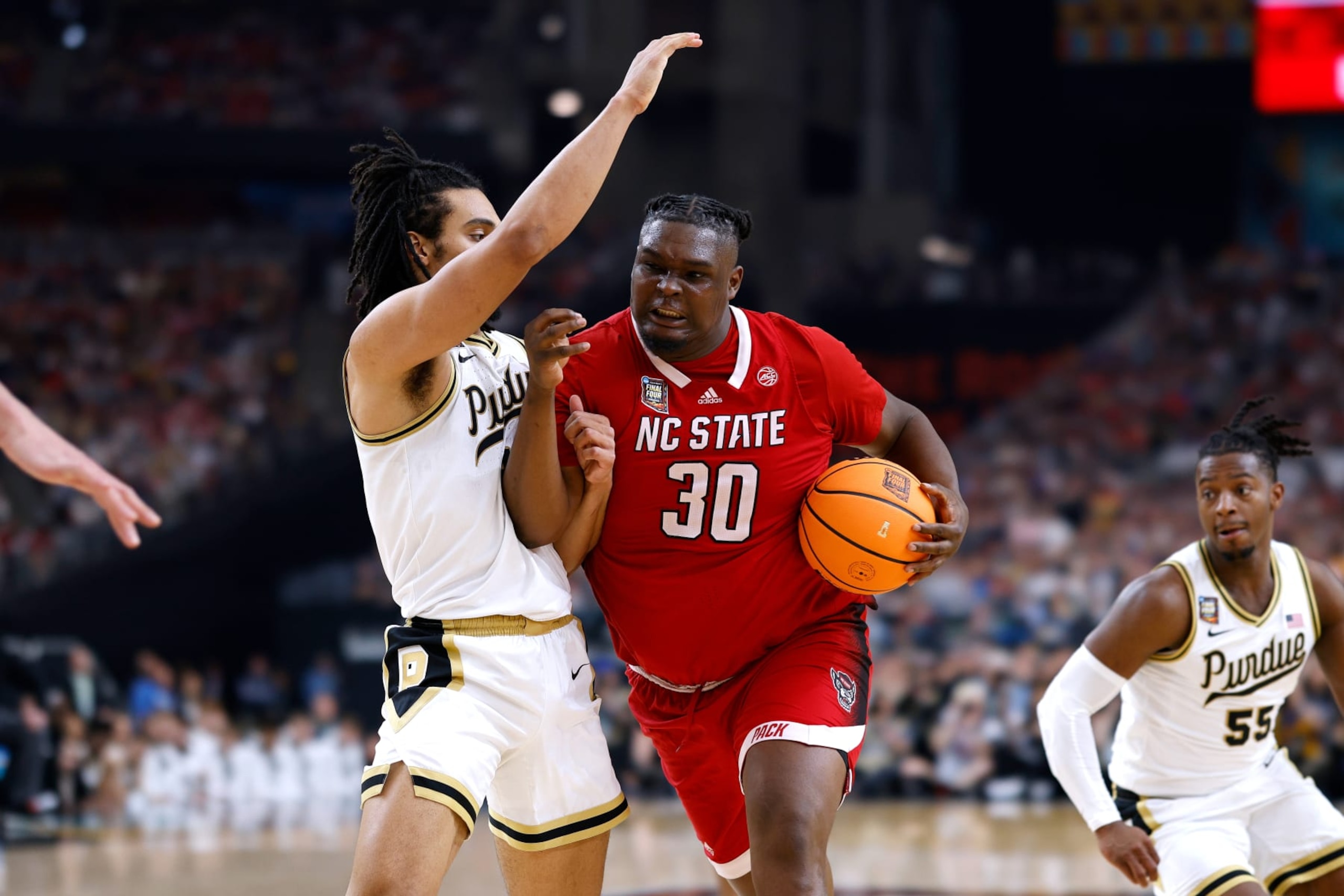 GLENDALE, ARIZONA - APRIL 06: DJ Burns Jr. #30 of the NC State Wolfpack drives with the ball against Trey Kaufman-Renn #4 of the Purdue Boilermakers during the second half in the NCAA Men's Basketball Tournament Final Four semifinal game at State Farm Stadium on April 6, 2024 in Glendale, Arizona. (Photo by Lance King/Getty Images)