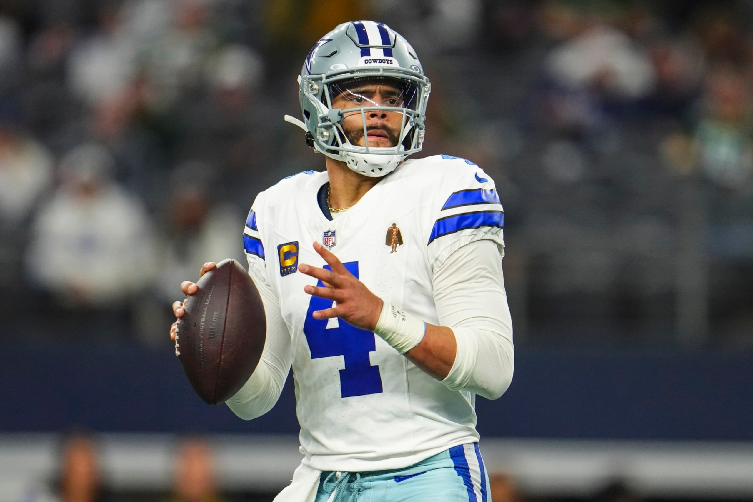 DALLAS, TX - JANUARY 14: Dak Prescott #4 of the Dallas Cowboys drops back to pass during an NFL wild-card playoff football game against the Green Bay Packers at AT&T Stadium on January 14, 2024 in Dallas, Texas. (Photo by Cooper Neill/Getty Images)