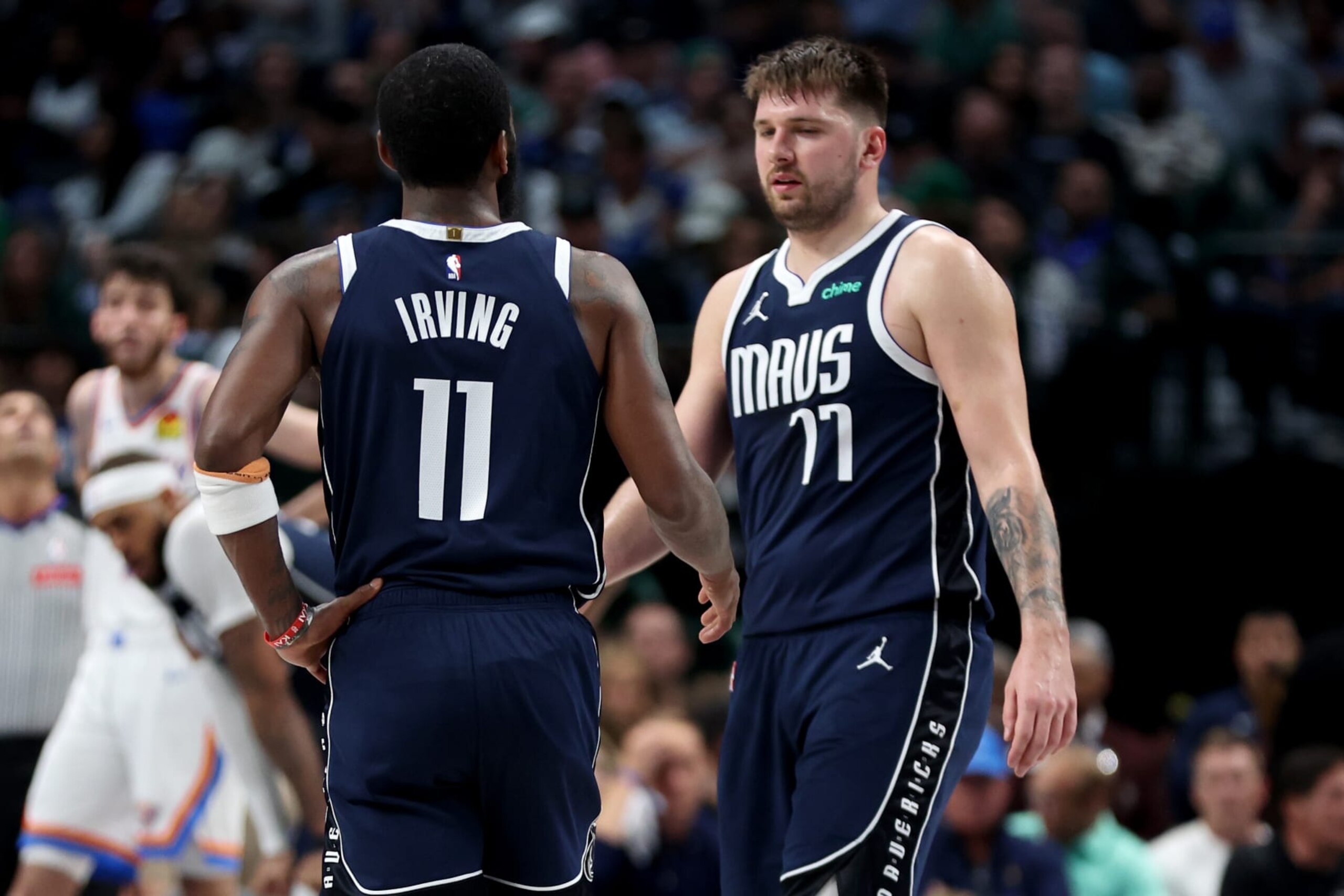 DALLAS, TEXAS - MAY 13: Kyrie Irving #11 of the Dallas Mavericks and Luka Doncic #77 of the Dallas Mavericks talk during a time out against the Oklahoma City Thunder in Game Four of the Western Conference Second Round Playoffs at American Airlines Center on May 11, 2024 in Dallas, Texas. NOTE TO USER: User expressly acknowledges and agrees that, by downloading and or using this photograph, User is consenting to the terms and conditions of the Getty Images License Agreement. (Photo by Tim Heitman/Getty Images) DALLAS, TEXAS - MAY 13: Kyrie Irving #11 of the Dallas Mavericks and Luka Doncic #77 of the Dallas Mavericks talk during a time out against the Oklahoma City Thunder in Game Four of the Western Conference Second Round Playoffs at American Airlines Center on May 11, 2024 in Dallas, Texas. NOTE TO USER: User expressly acknowledges and agrees that, by downloading and or using this photograph, User is consenting to the terms and conditions of the Getty Images License Agreement. (Photo by Tim Heitman/Getty Images)