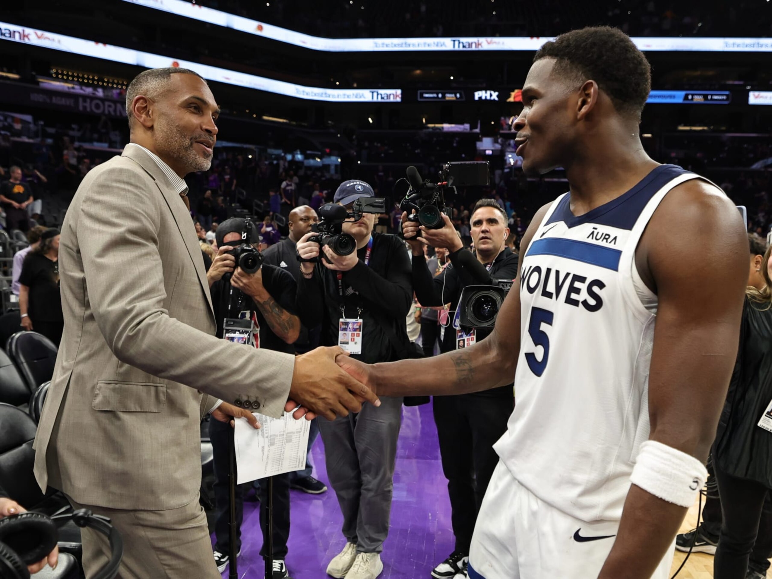PHOENIX, AZ - APRIL 28: Anthony Edwards #5 of the Minnesota Timberwolves embraces Grant Hill after the game against the Phoenix Suns during Round 1 Game 4 on April 28, 2024 at the Footprint Center in Phoenix, Arizona. NOTE TO USER: User expressly acknowledges and agrees that, by downloading and/or using this Photograph, user is consenting to the terms and conditions of the Getty Images License Agreement. Mandatory Copyright Notice: Copyright 2024 NBAE (Photo by Jim Poorten/NBAE via Getty Images)