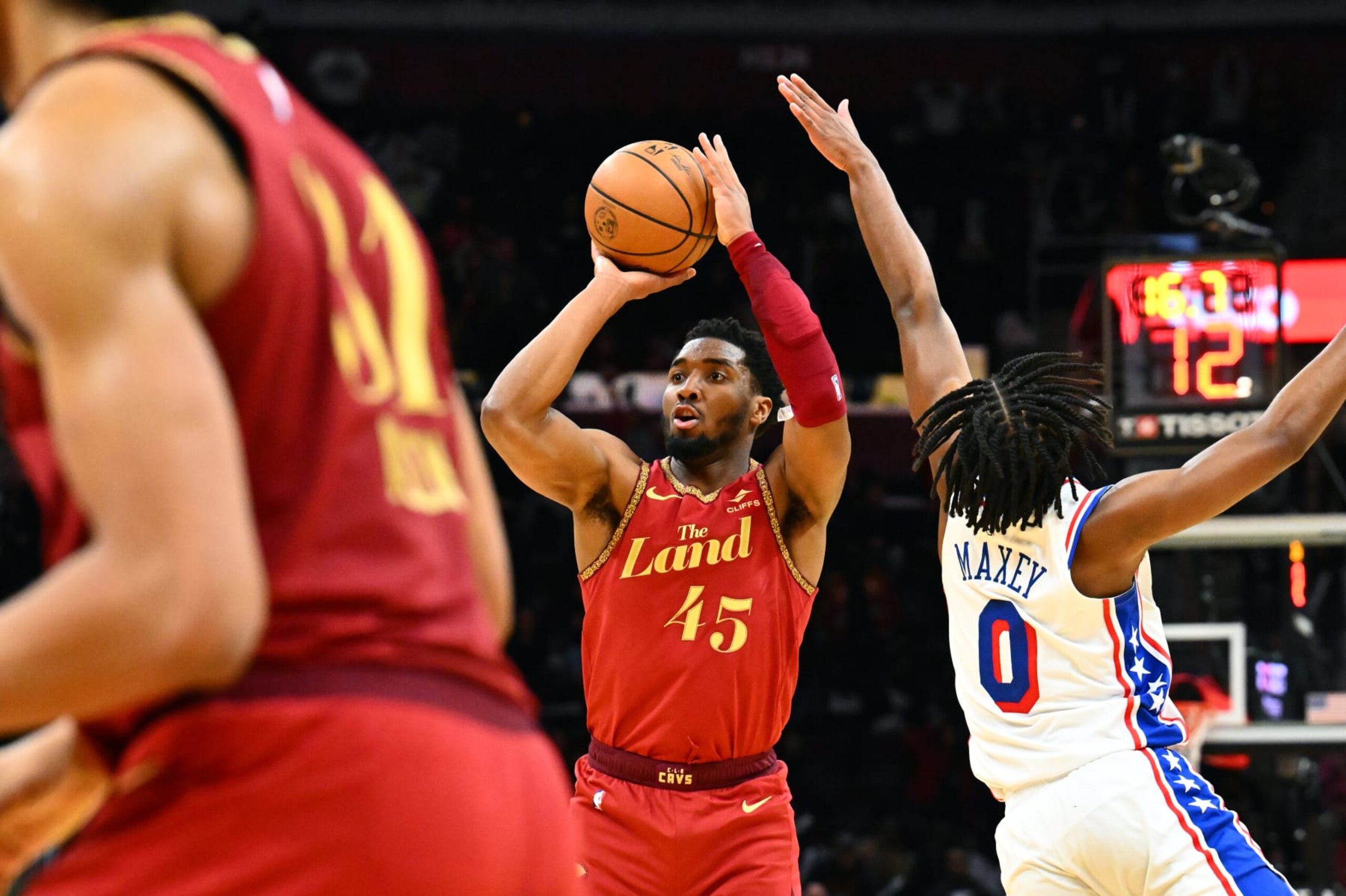 CLEVELAND, OHIO - FEBRUARY 12: Donovan Mitchell #45 of the Cleveland Cavaliers shoots over Tyrese Maxey #0 of the Philadelphia 76ers during the fourth quarter at Rocket Mortgage Fieldhouse on February 12, 2024 in Cleveland, Ohio. The 76ers defeated the Cavaliers 123-121. NOTE TO USER: User expressly acknowledges and agrees that, by downloading and or using this photograph, User is consenting to the terms and conditions of the Getty Images License Agreement. (Photo by Jason Miller/Getty Images)