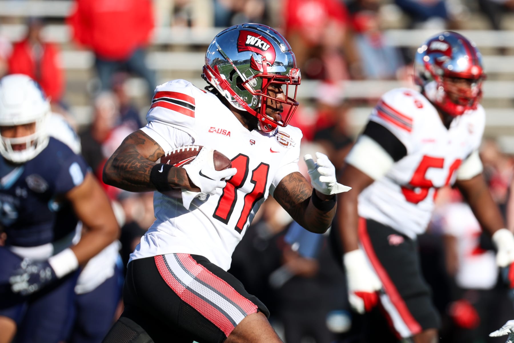 CHARLOTTE, NORTH CAROLINA - DECEMBER 18: Malachi Corley #11 of the Western Kentucky Hilltoppers runs the ball against the Old Dominion Monarchs during the first half of the Famous Toastery Bowl at Jerry Richardson Stadium on December 18, 2023 in Charlotte, North Carolina. (Photo by Isaiah Vazquez/Getty Images)