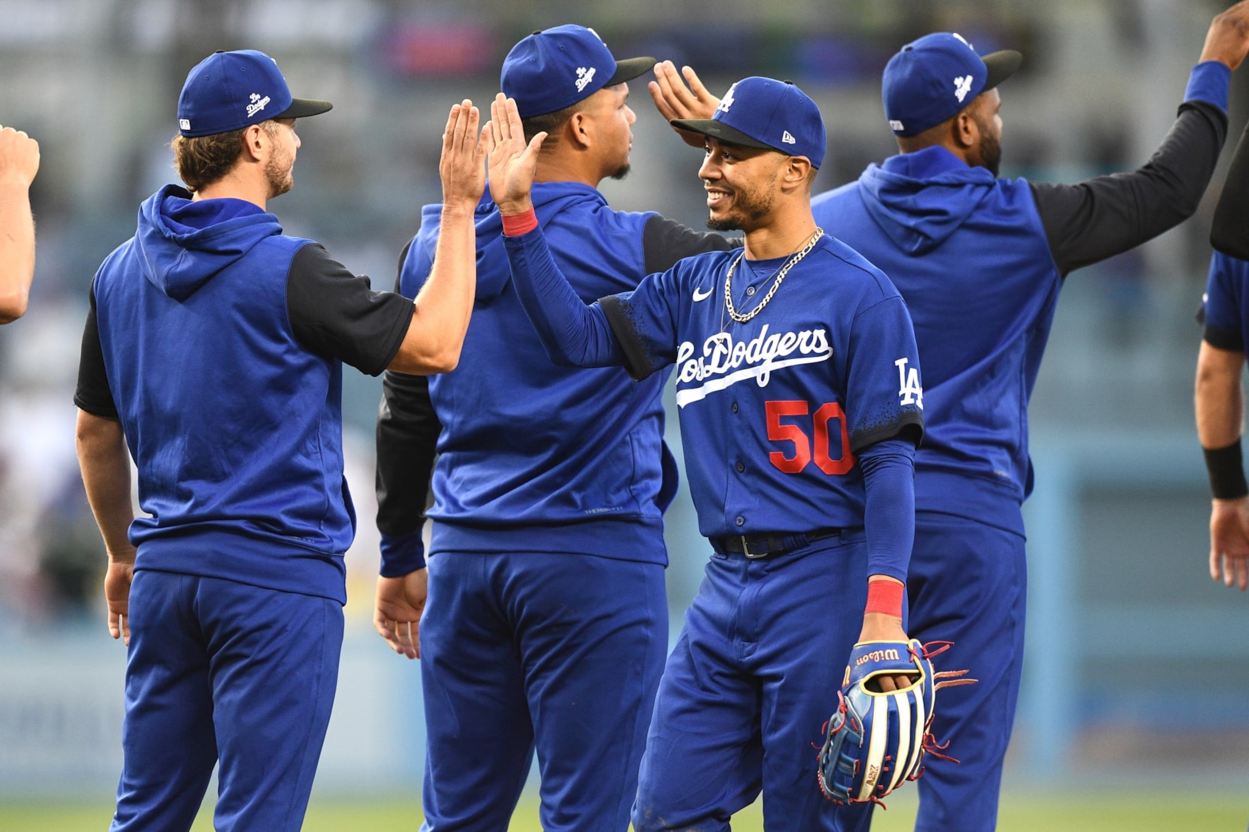 LOS ANGELES, CA - JULY 23: Los Angeles Dodgers right fielder Mookie Betts (50) gets a high five after the MLB game between the San Francisco Giants and the Los Angeles Dodgers on July 23, 2022 at Dodger Stadium in Los Angeles, CA. (Photo by Brian Rothmuller/Icon Sportswire via Getty Images)