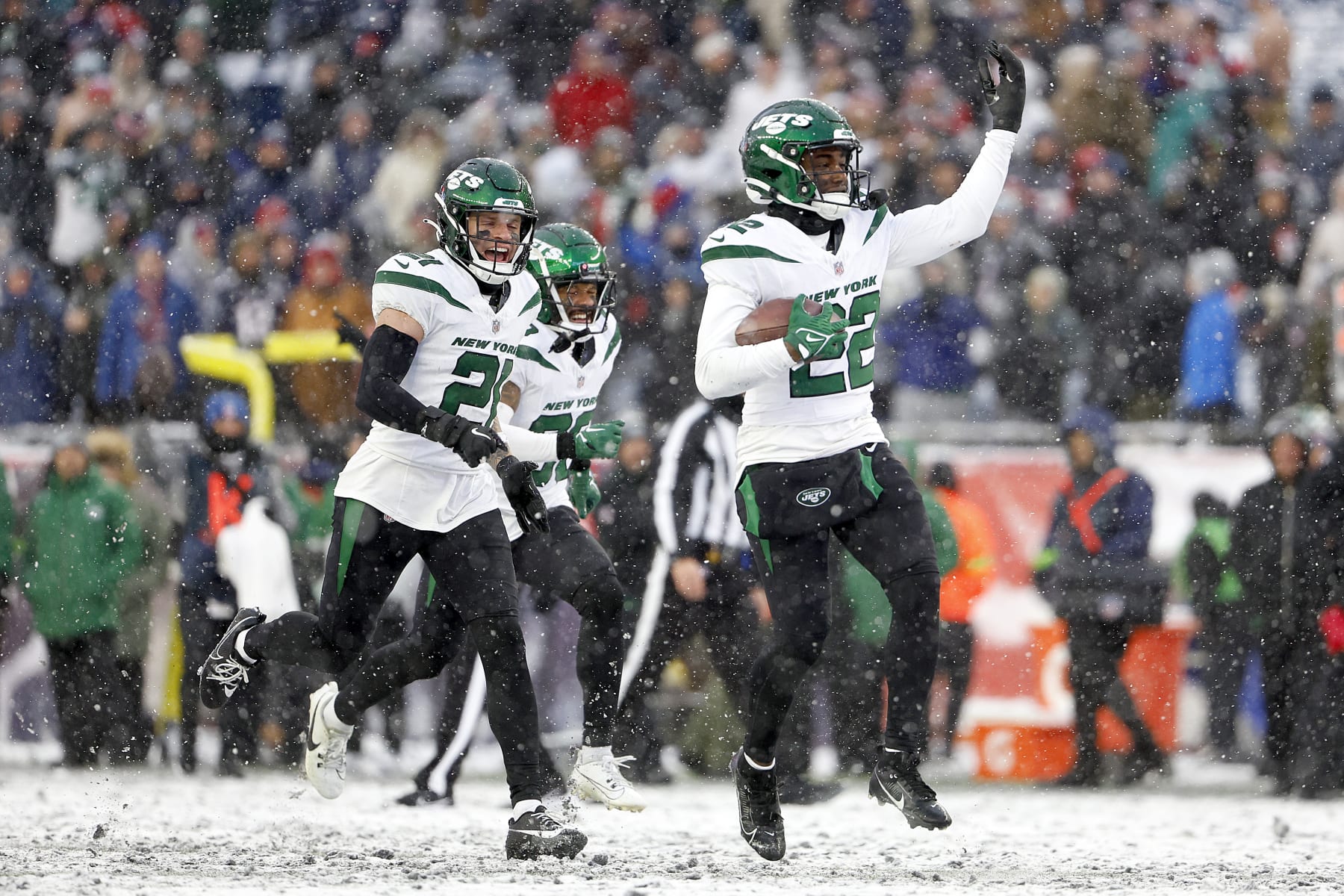 FOXBOROUGH, MASSACHUSETTS - JANUARY 07: Ashtyn Davis #21, Michael Carter II #30 and Tony Adams #22 of the New York Jets celebrate in the snow after an interception in the fourth quarter during a game against the New England Patriots at Gillette Stadium on January 07, 2024 in Foxborough, Massachusetts. (Photo by Winslow Townson/Getty Images)