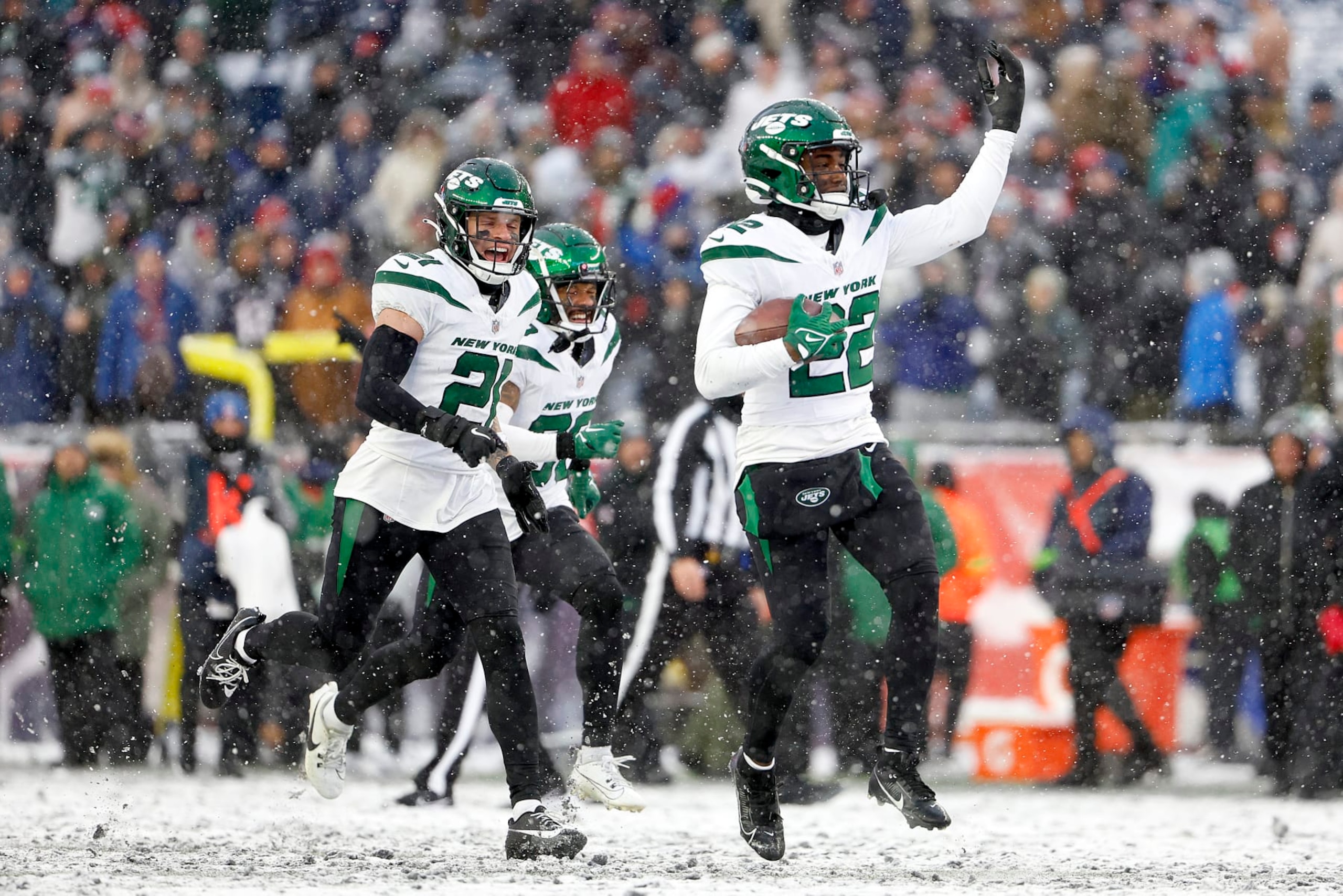 FOXBOROUGH, MASSACHUSETTS - JANUARY 07: Ashtyn Davis #21, Michael Carter II #30 and Tony Adams #22 of the New York Jets celebrate in the snow after an interception in the fourth quarter during a game against the New England Patriots at Gillette Stadium on January 07, 2024 in Foxborough, Massachusetts. (Photo by Winslow Townson/Getty Images)