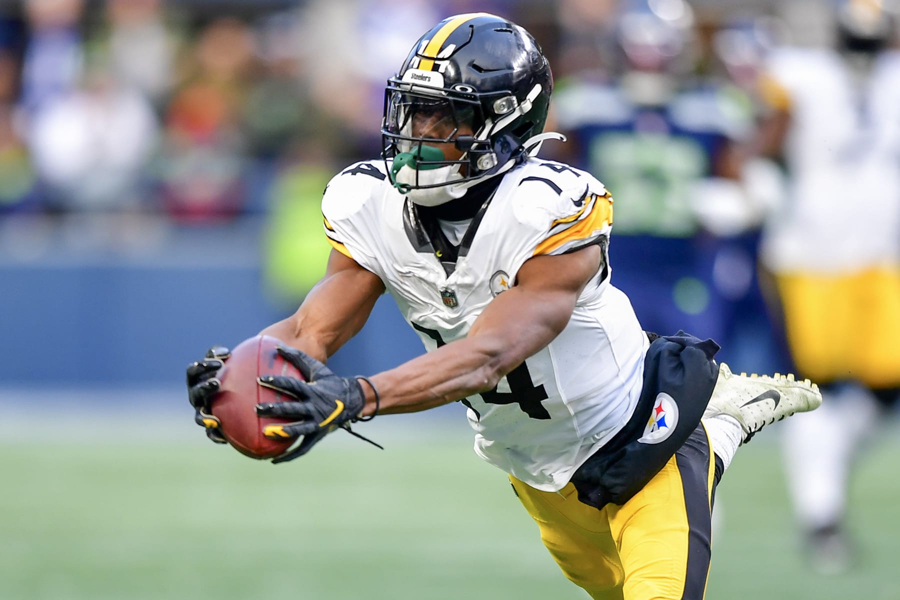 SEATTLE, WASHINGTON - DECEMBER 31: George Pickens #14 of the Pittsburgh Steelers reacts after catching a pass for a first down during the fourth quarter against the Seattle Seahawks at Lumen Field on December 31, 2023 in Seattle, Washington. (Photo by Jane Gershovich/Getty Images)