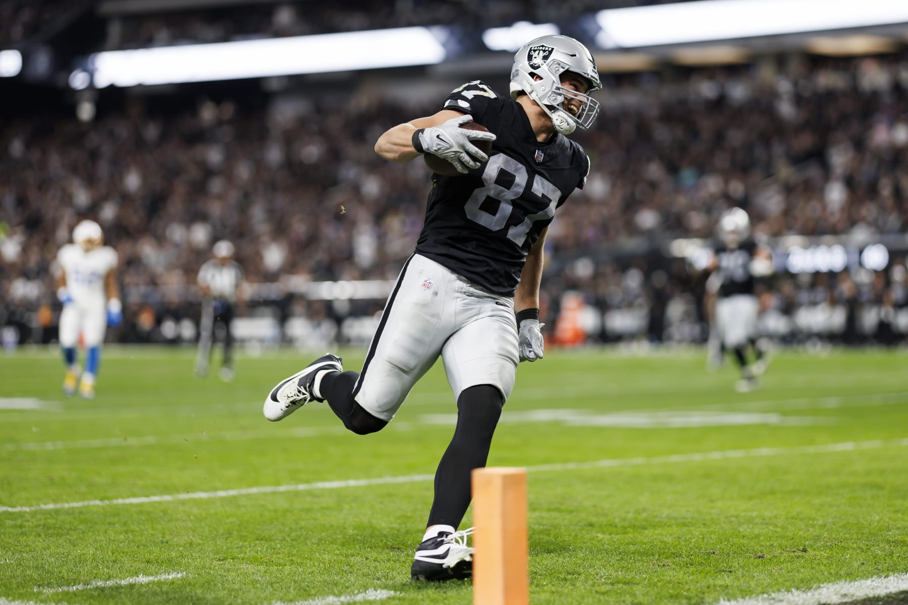 LAS VEGAS, NEVADA - DECEMBER 14: Michael Mayer #87 of the Las Vegas Raiders runs the ball after a catch to score a touchdown during an NFL football game against the Los Angeles Chargers at Allegiant Stadium on December 14, 2023 in Las Vegas, Nevada. (Photo by Ryan Kang/Getty Images)