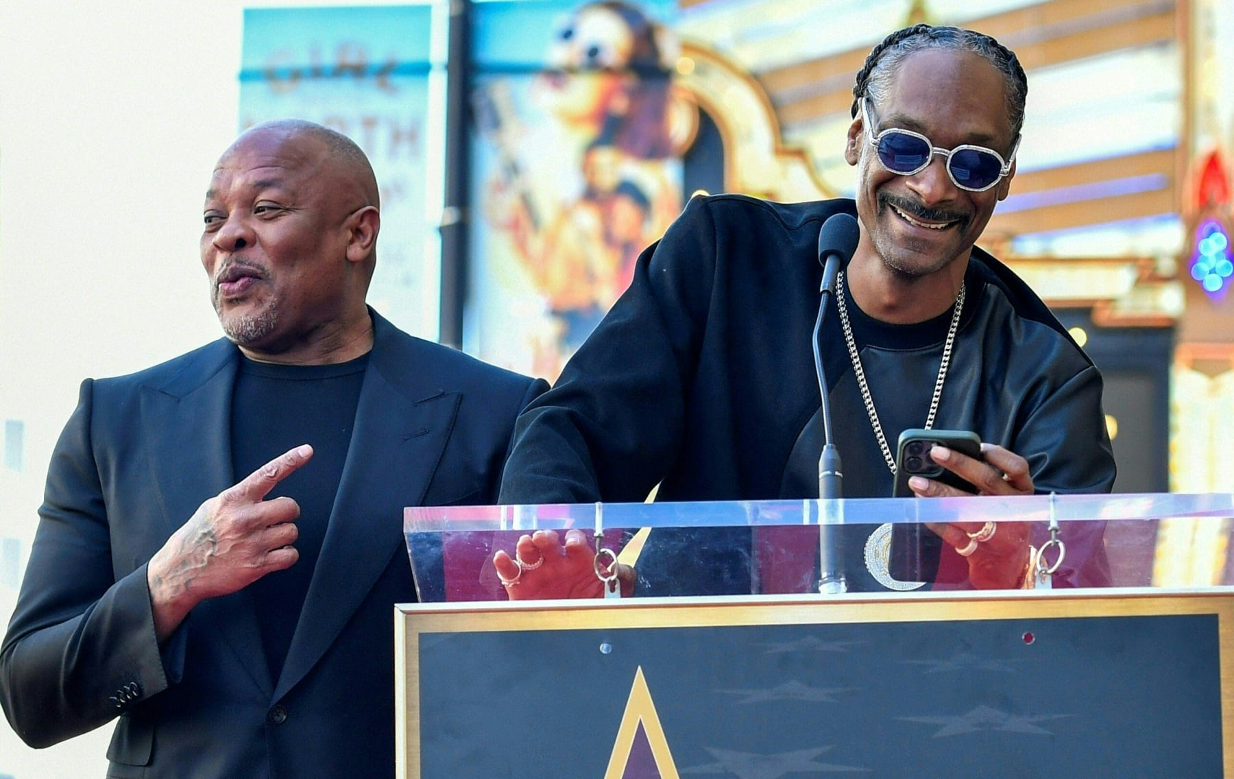 US rapper Dr. Dre (L) reacts as US rapper Snoop Dog speaks at Dr. Dre's Hollywood Walk of Fame ceremony in Hollywood, California, on March 19, 2024. (Photo by VALERIE MACON / AFP) (Photo by VALERIE MACON/AFP via Getty Images)
