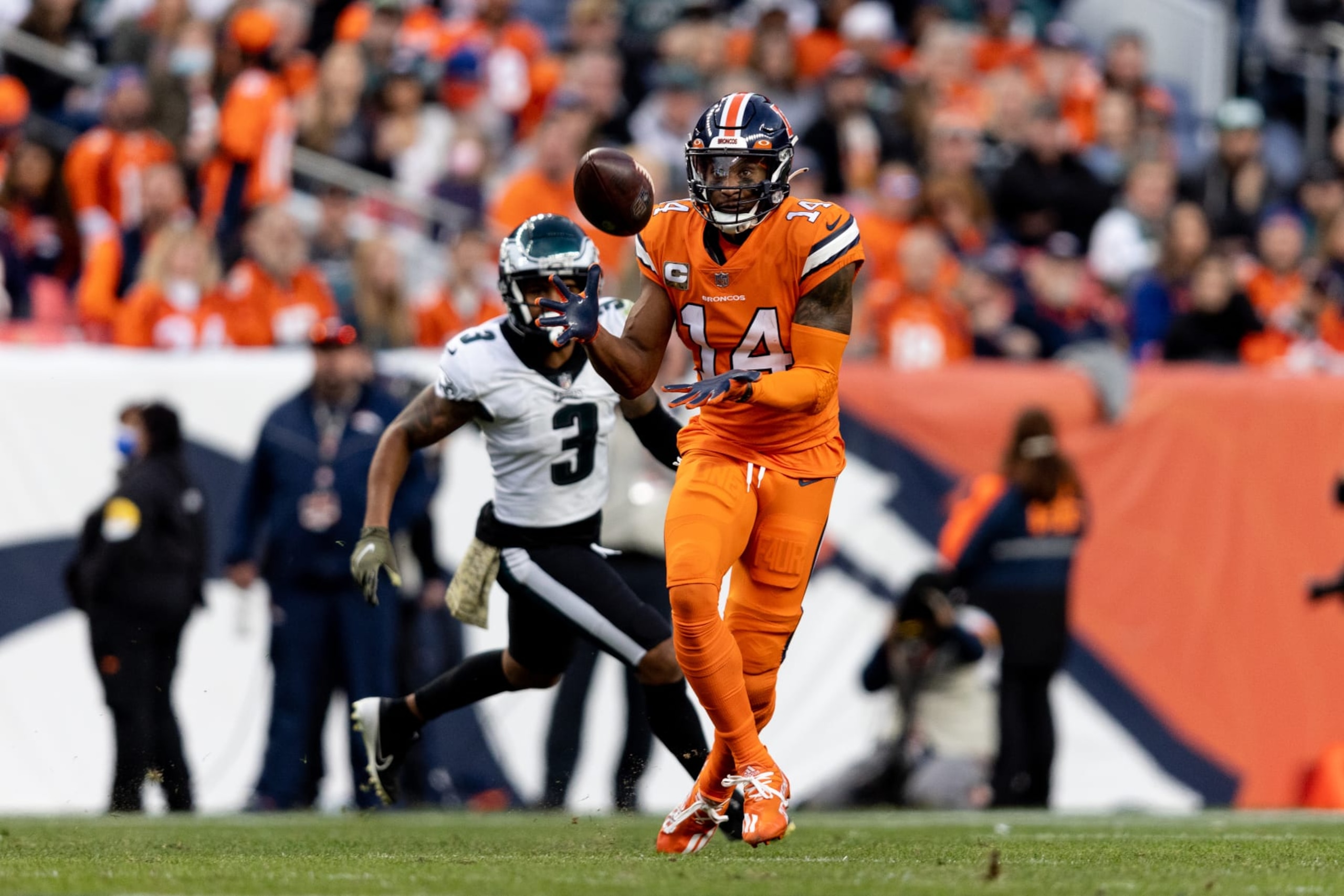 DENVER, COLORADO - NOVEMBER 14: Courtland Sutton #14 of the Denver Broncos completes a pass against Steven Nelson #3 of the Philadelphia Eagles during the second half of an NFL football game at Empower Field on November 14, 2021 in Denver, Colorado. (Photo by Michael Owens/Getty Images)