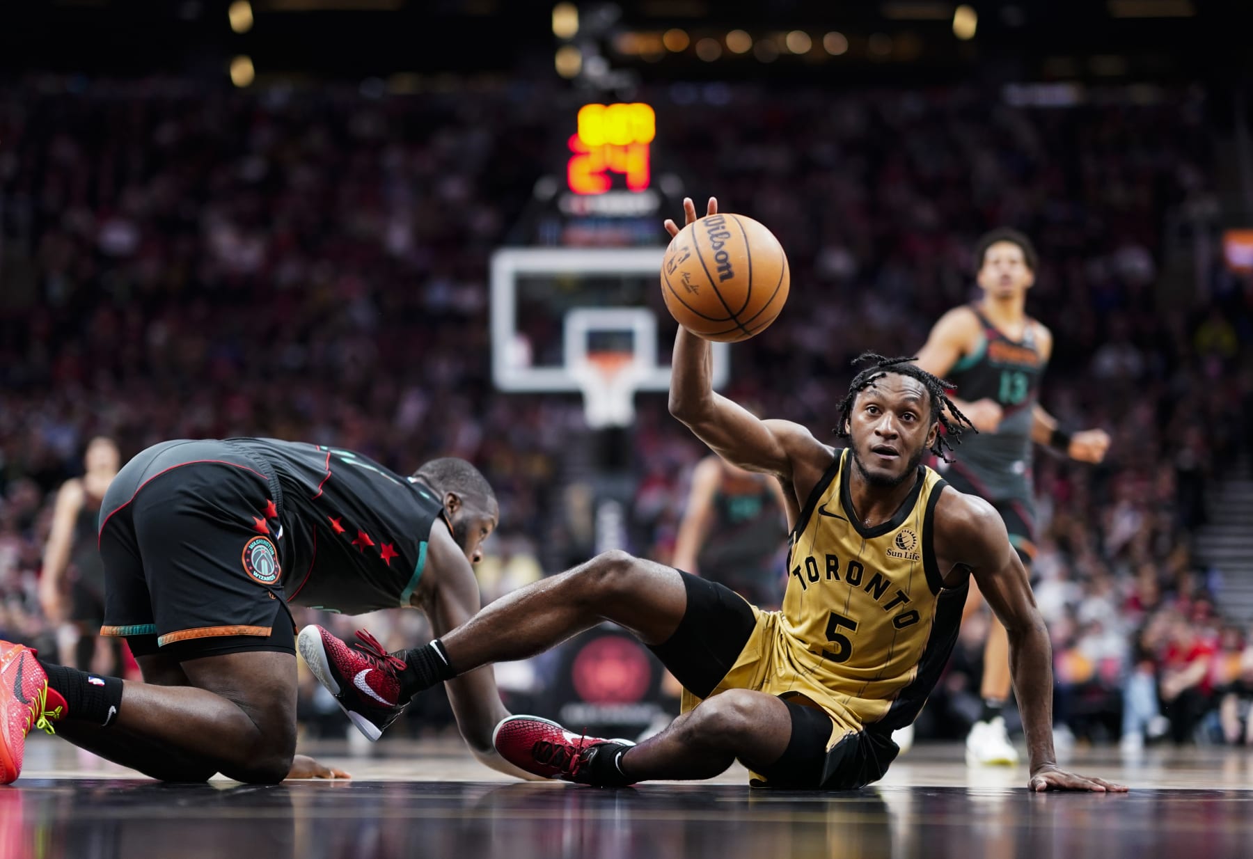TORONTO, ON - APRIL 7: Immanuel Quickley #5 of the Toronto Raptors battles for a loose ball against the Washington Wizards during the second half of their basketball game at the Scotiabank Arena on April 7, 2024 in Toronto, Ontario, Canada. NOTE TO USER: User expressly acknowledges and agrees that, by downloading and/or using this Photograph, user is consenting to the terms and conditions of the Getty Images License Agreement. (Photo by Mark Blinch/Getty Images)