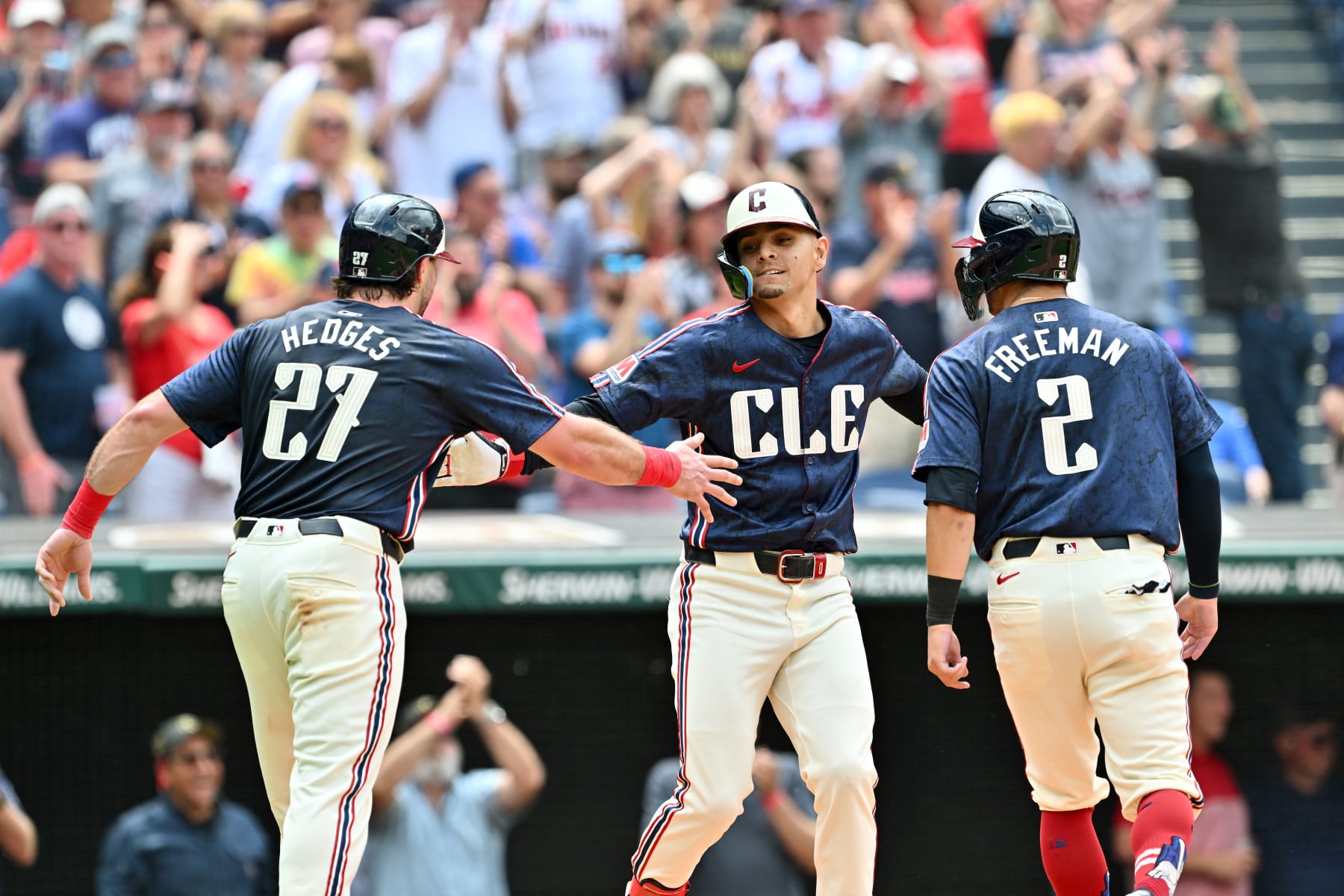 CLEVELAND, OHIO - MAY 22: Austin Hedges #27, Andrés Giménez #0, and Tyler Freeman #2 of the Cleveland Guardians celebrate after all scored on a homer by Giménez during the sixth inning against the New York Mets at Progressive Field on May 22, 2024 in Cleveland, Ohio. (Photo by Jason Miller/Getty Images)