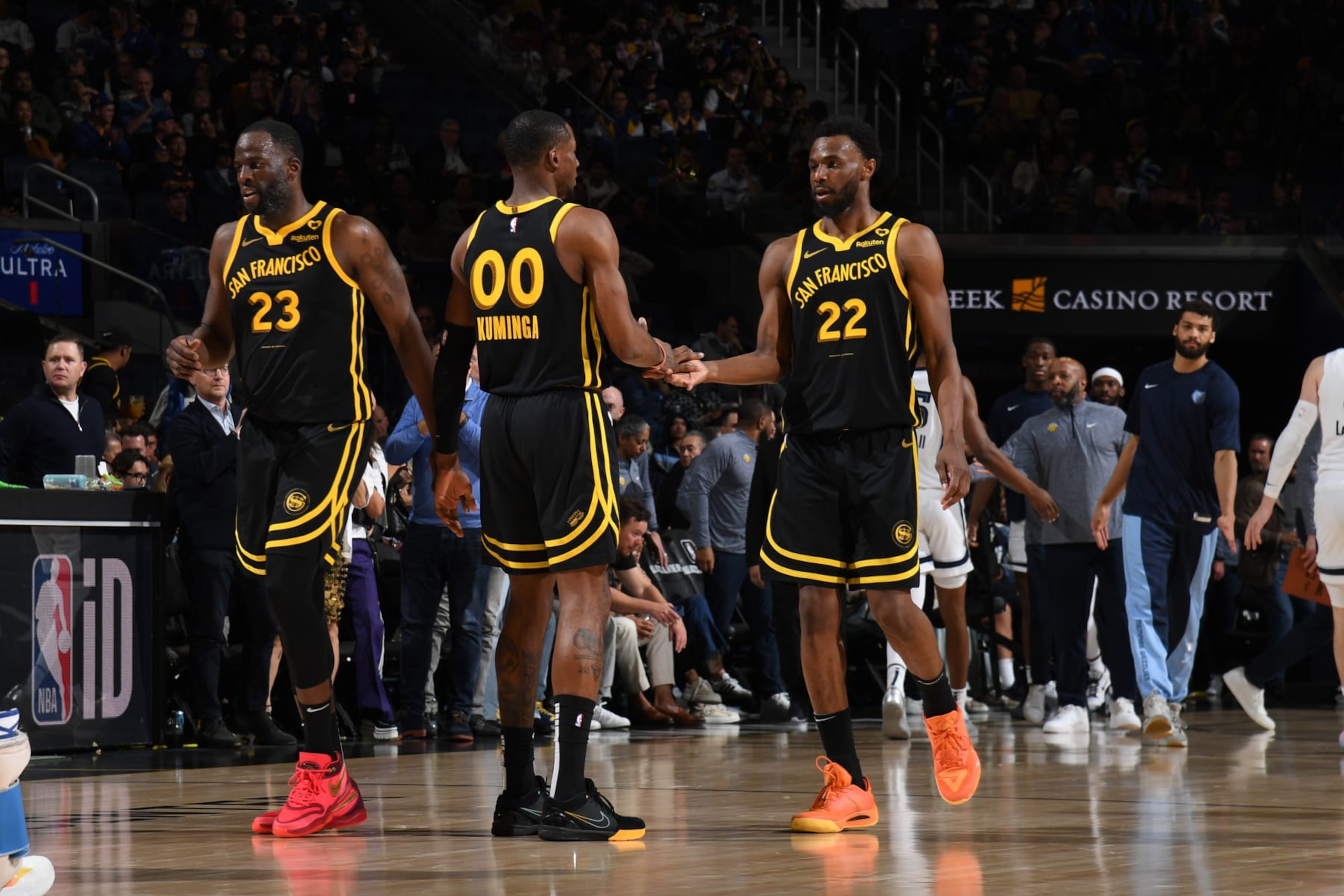 SAN FRANCISCO, CA - MARCH 20: Jonathan Kuminga #00 and Andrew Wiggins #22 of the Golden State Warriors high five during the game against the Memphis Grizzlies on March 20, 2024 at Chase Center in San Francisco, California. NOTE TO USER: User expressly acknowledges and agrees that, by downloading and or using this photograph, user is consenting to the terms and conditions of Getty Images License Agreement. Mandatory Copyright Notice: Copyright 2024 NBAE (Photo by Noah Graham/NBAE via Getty Images)