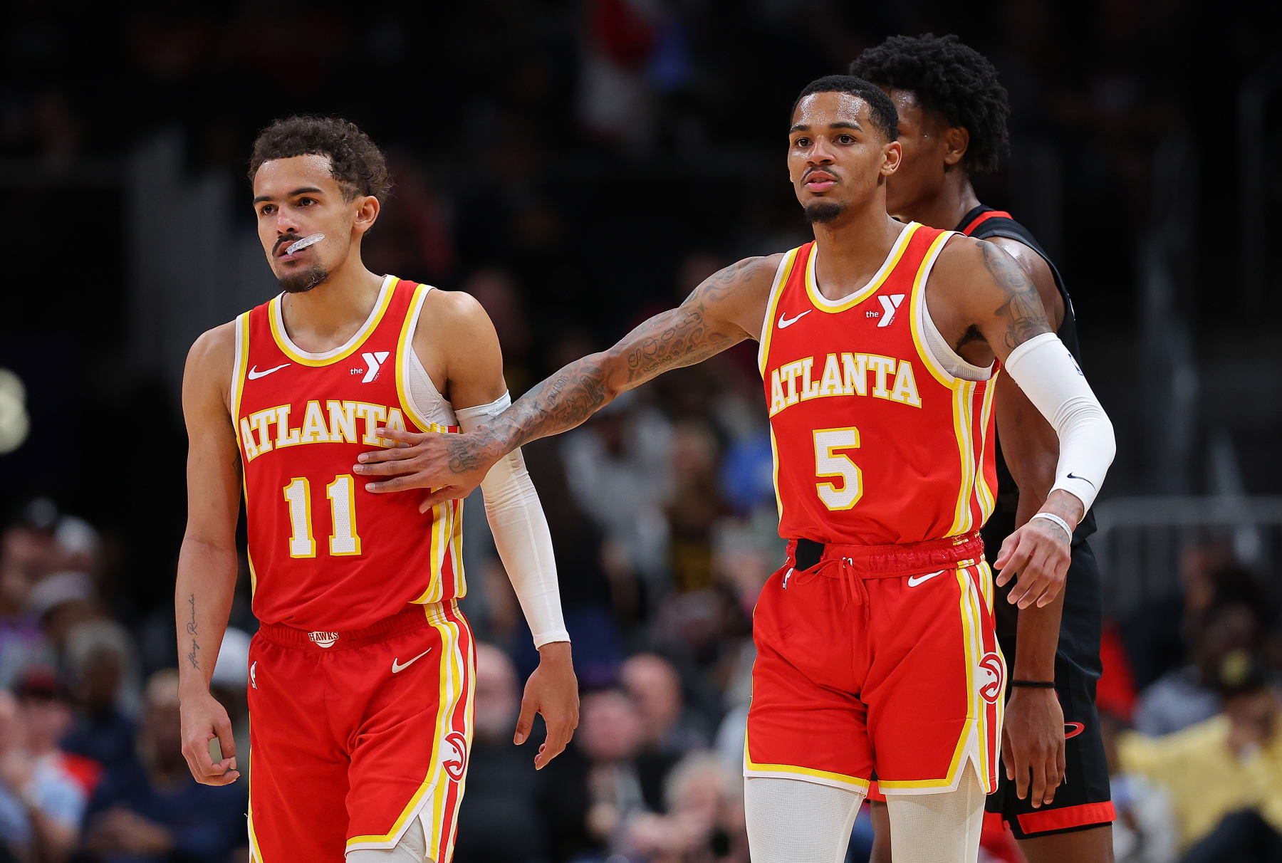 ATLANTA, GEORGIA - FEBRUARY 10:  Trae Young #11 and Dejounte Murray #5 of the Atlanta Hawks react against the Houston Rockets during the fourth quarter at State Farm Arena on February 10, 2024 in Atlanta, Georgia.  NOTE TO USER: User expressly acknowledges and agrees that, by downloading and/or using this photograph, user is consenting to the terms and conditions of the Getty Images License Agreement.  (Photo by Kevin C. Cox/Getty Images)
