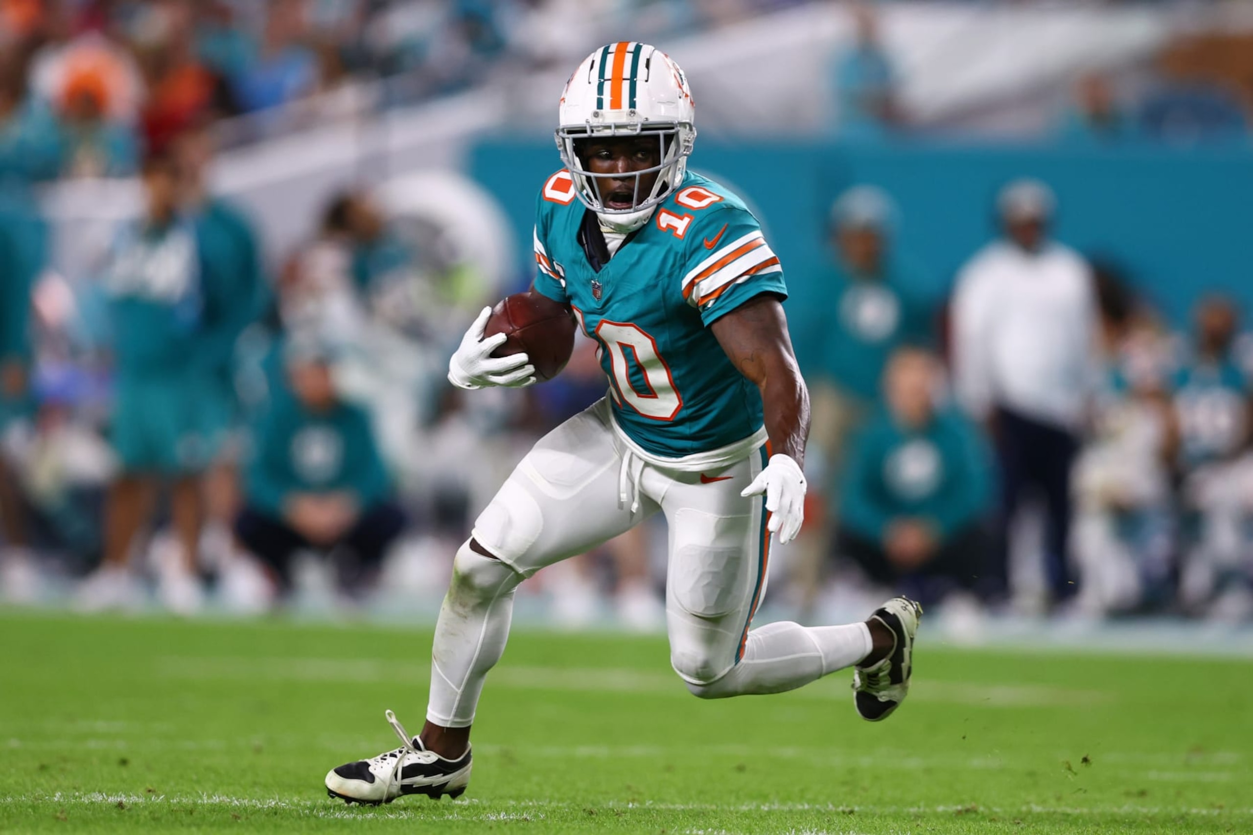 MIAMI GARDENS, FLORIDA - DECEMBER 24: Tyreek Hill #10 of the Miami Dolphins carries the ball against the Dallas Cowboys during the fourth quarter of the game at Hard Rock Stadium on December 24, 2023 in Miami Gardens, Florida. (Photo by Megan Briggs/Getty Images) MIAMI GARDENS, FLORIDA - DECEMBER 24: Tyreek Hill #10 of the Miami Dolphins carries the ball against the Dallas Cowboys during the fourth quarter of the game at Hard Rock Stadium on December 24, 2023 in Miami Gardens, Florida. (Photo by Megan Briggs/Getty Images)