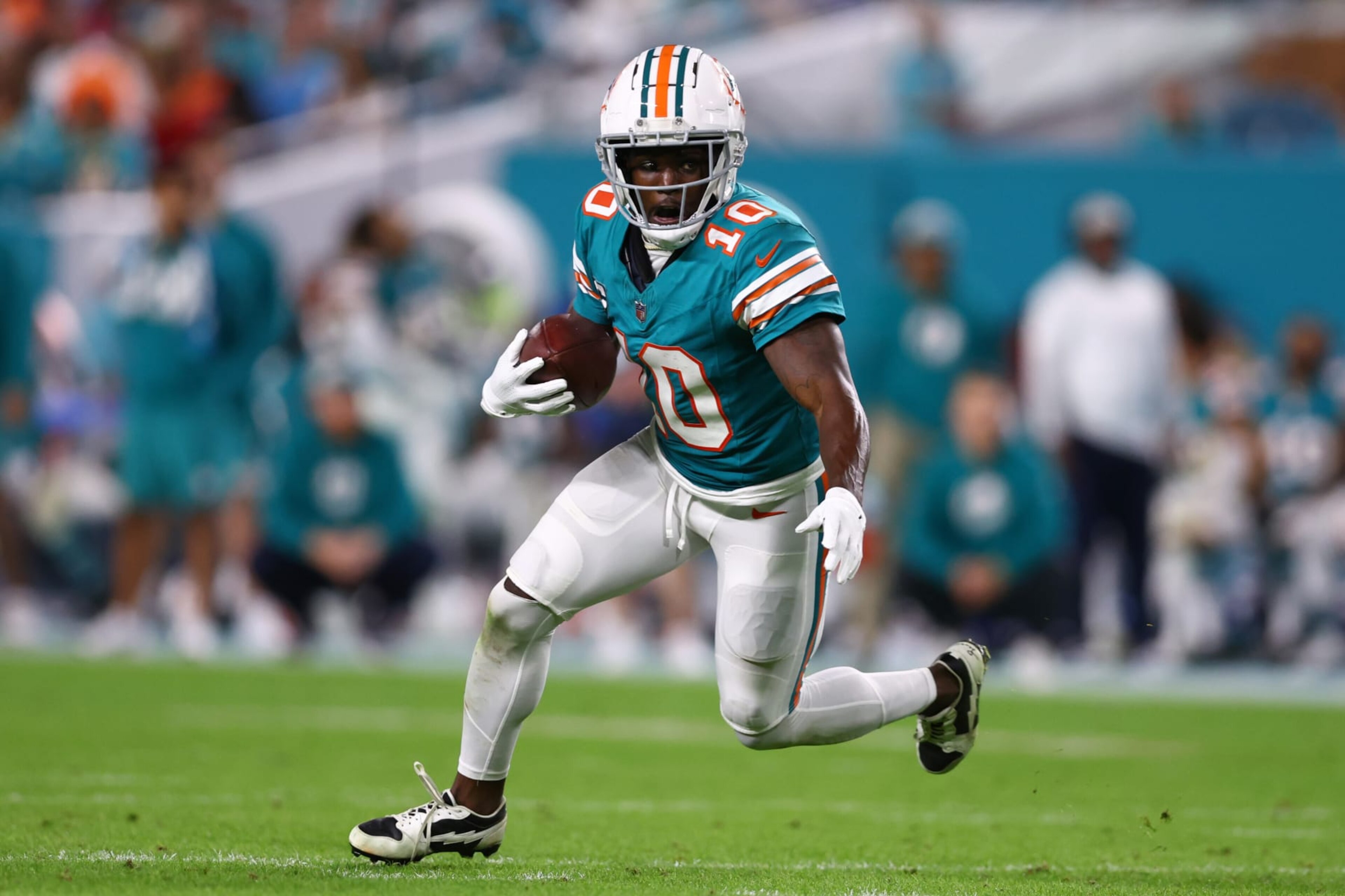MIAMI GARDENS, FLORIDA - DECEMBER 24: Tyreek Hill #10 of the Miami Dolphins carries the ball against the Dallas Cowboys during the fourth quarter of the game at Hard Rock Stadium on December 24, 2023 in Miami Gardens, Florida. (Photo by Megan Briggs/Getty Images)