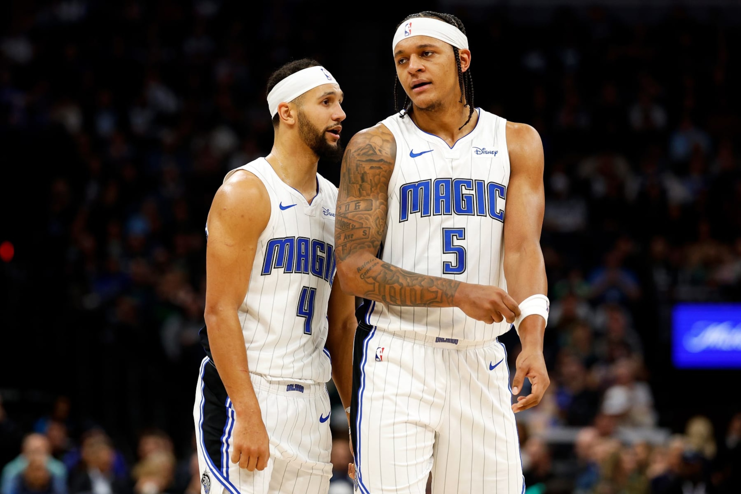 MINNEAPOLIS, MINNESOTA - FEBRUARY 02: Jalen Suggs #4 and Paolo Banchero #5 of the Orlando Magic interact in the third quarter against the Minnesota Timberwolves at Target Center on February 02, 2024 in Minneapolis, Minnesota. The Magic defeated the Timberwolves 108-106. NOTE TO USER: User expressly acknowledges and agrees that, by downloading and or using this photograph, User is consenting to the terms and conditions of the Getty Images License Agreement. (Photo by David Berding/Getty Images)