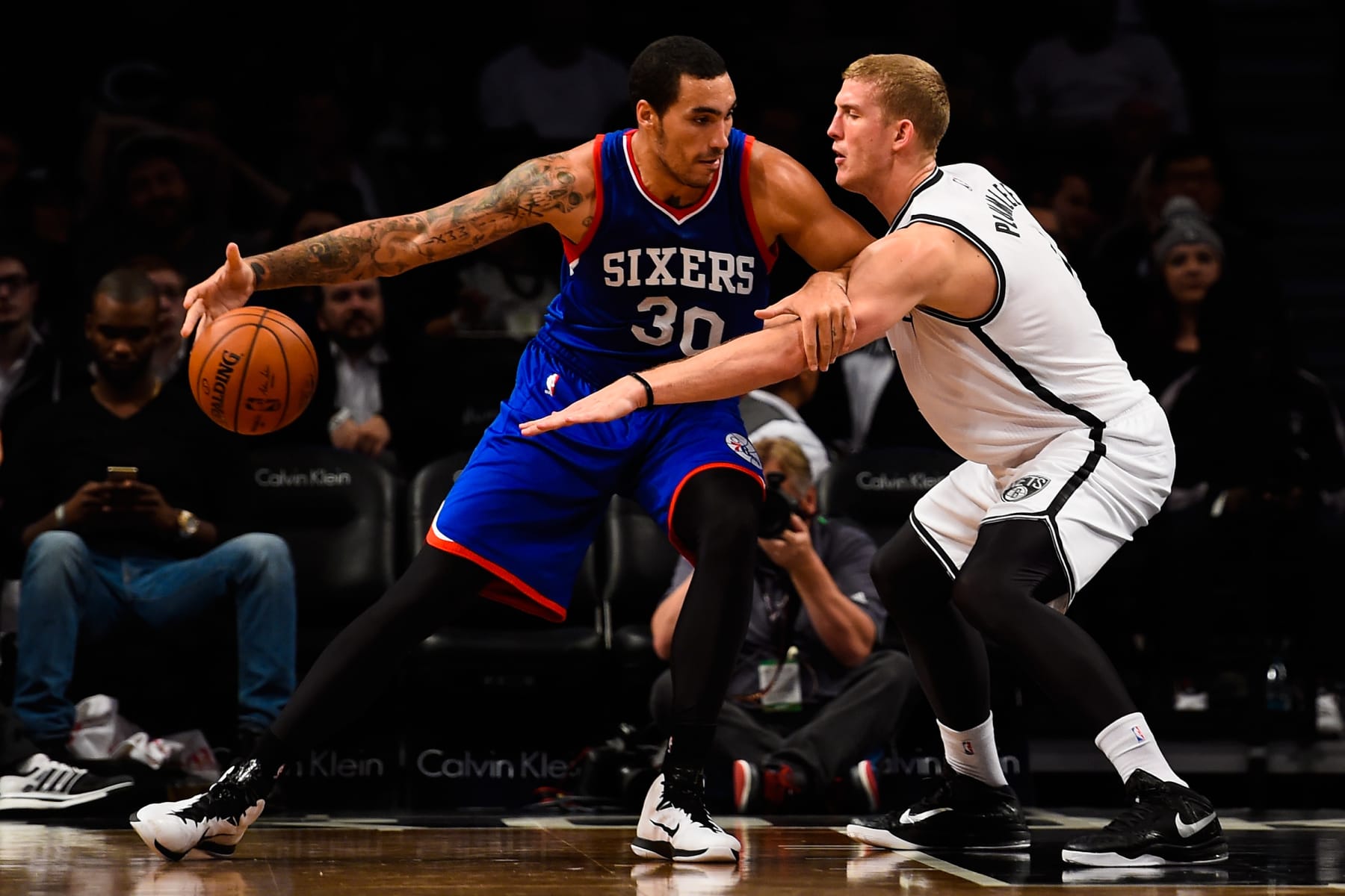 NEW YORK, NY - OCTOBER 20: Drew Gordon #30 of the Philadelphia 76ers attempts to dribble around Mason Plumlee #1 of the Brooklyn Nets in a preseason game at the Barclays Center on October 20, 2014 in New York City. NOTE TO USER: User expressly acknowledges and agrees that, by downloading and/or using this photograph, user is consenting to the terms and conditions of the Getty Images License Agreement.  (Photo by Alex Goodlett/Getty Images)