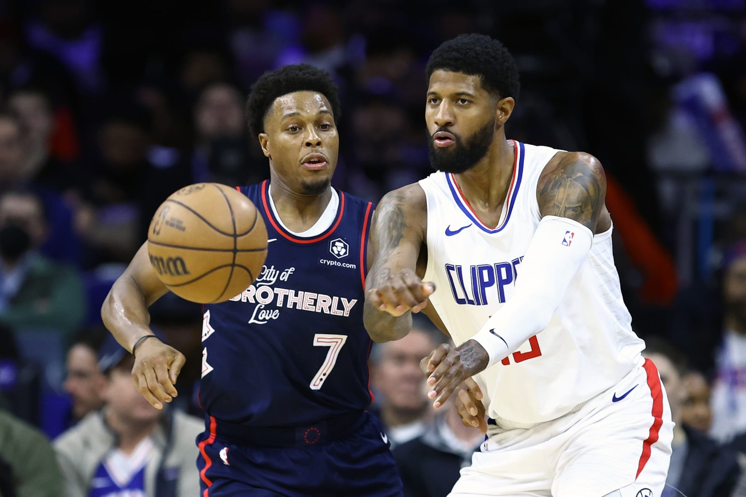 PHILADELPHIA, PENNSYLVANIA - MARCH 27: Paul George #13 of the LA Clippers passes past Kyle Lowry #7 of the Philadelphia 76ers during the third quarter at the Wells Fargo Center on March 27, 2024 in Philadelphia, Pennsylvania. NOTE TO USER: User expressly acknowledges and agrees that, by downloading and or using this photograph, User is consenting to the terms and conditions of the Getty Images License Agreement. (Photo by Tim Nwachukwu/Getty Images)
