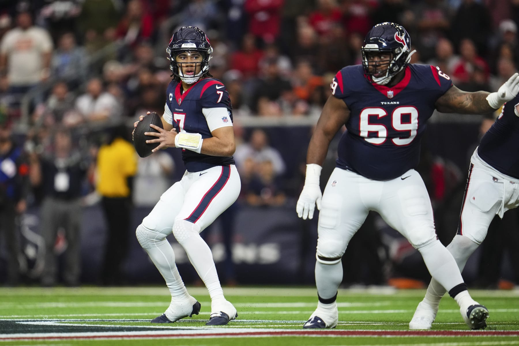 HOUSTON, TX - JANUARY 13: C.J. Stroud #7 of the Houston Texans drops back to pass during an NFL wild-card playoff football game against the Cleveland Browns at NRG Stadium on January 13, 2024 in Houston, Texas. (Photo by Cooper Neill/Getty Images)