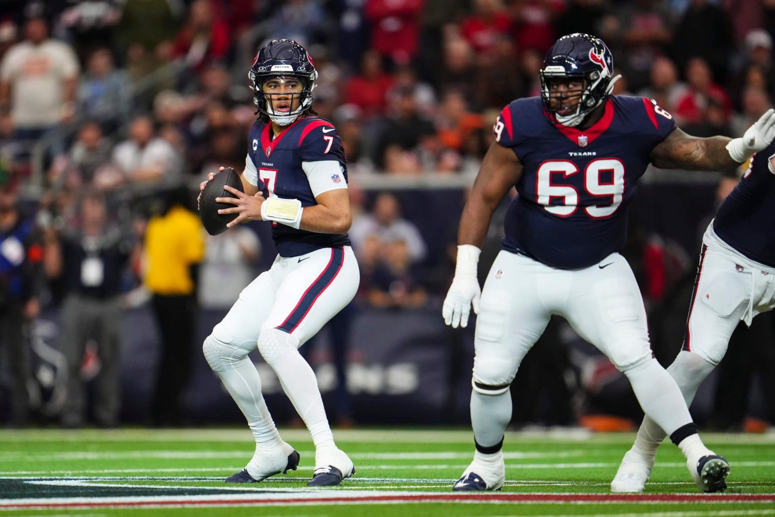 HOUSTON, TX - JANUARY 13: C.J. Stroud #7 of the Houston Texans drops back to pass during an NFL wild-card playoff football game against the Cleveland Browns at NRG Stadium on January 13, 2024 in Houston, Texas. (Photo by Cooper Neill/Getty Images) HOUSTON, TX - JANUARY 13: C.J. Stroud #7 of the Houston Texans drops back to pass during an NFL wild-card playoff football game against the Cleveland Browns at NRG Stadium on January 13, 2024 in Houston, Texas. (Photo by Cooper Neill/Getty Images)