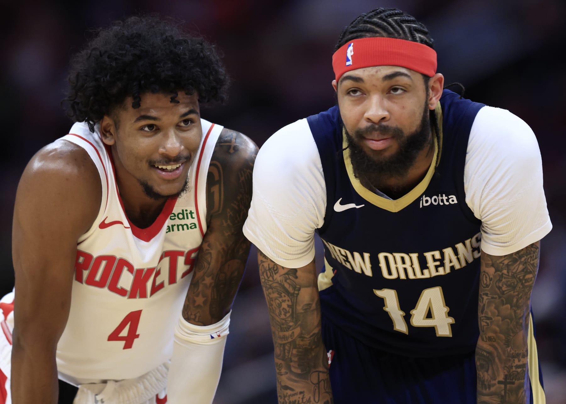 HOUSTON, TEXAS - JANUARY 31: Brandon Ingram #14 of the New Orleans Pelicans stands alongside Jalen Green #4 of the Houston Rockets during the first half at Toyota Center on January 31, 2024 in Houston, Texas. NOTE TO USER: User expressly acknowledges and agrees that, by downloading and or using this photograph, User is consenting to the terms and conditions of the Getty Images License Agreement.  (Photo by Carmen Mandato/Getty Images)