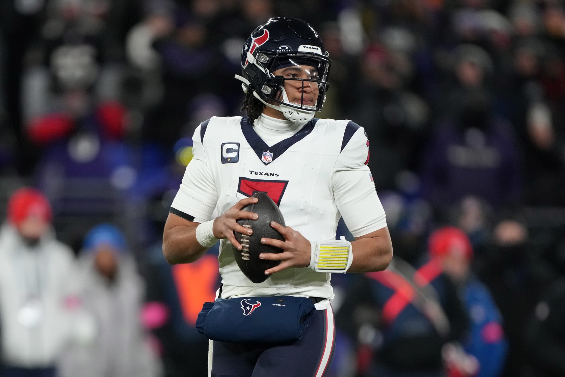 BALTIMORE, MARYLAND, JANUARY 20: Quarterback C.J. Stroud #7 of the Houston Texans looks to throw the ball against the Baltimore Ravens in the AFC Divisional Playoff game at M&T Bank Stadium on January 20, 2024 in Baltimore, Maryland. The Ravens defeated the Texans 34-10. (Photo by Kirby Lee/Getty Images)