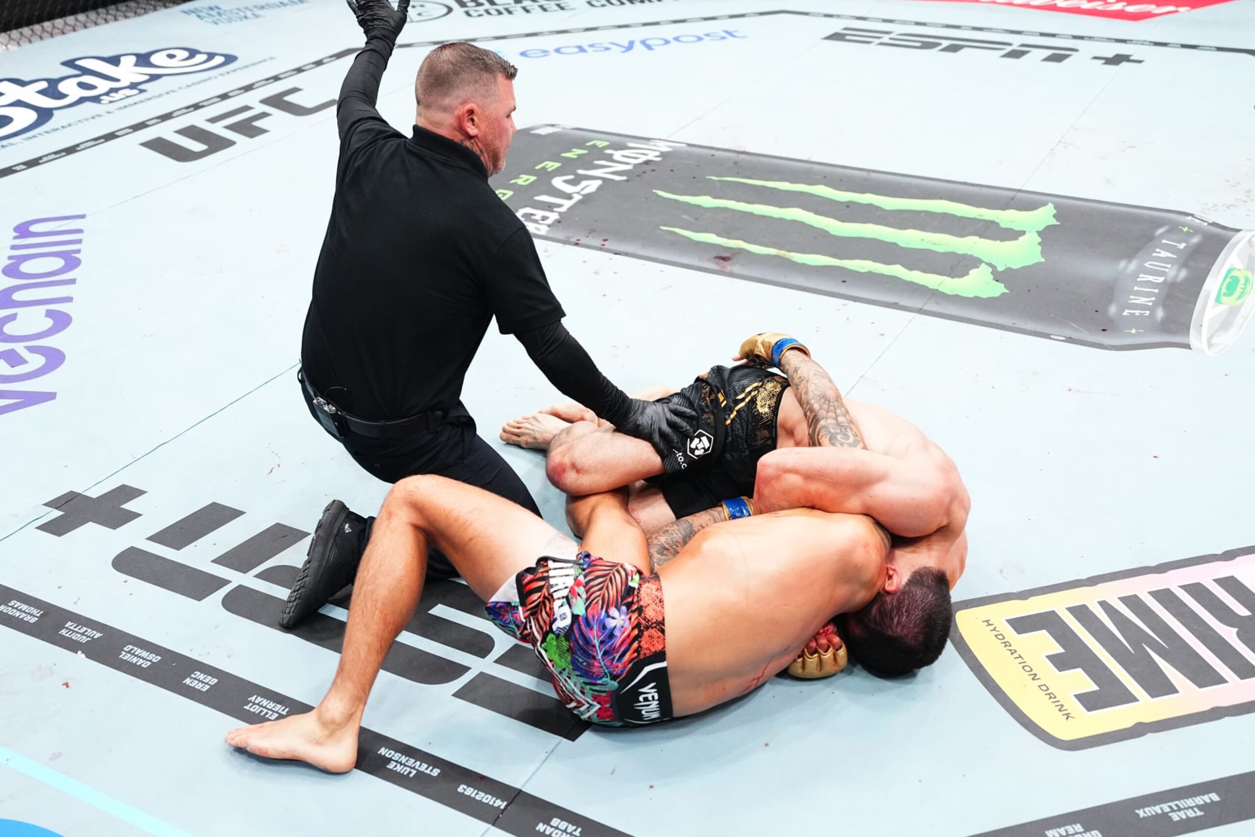 Islam Makhachev taps Dustin Poirier with a D'arce choke