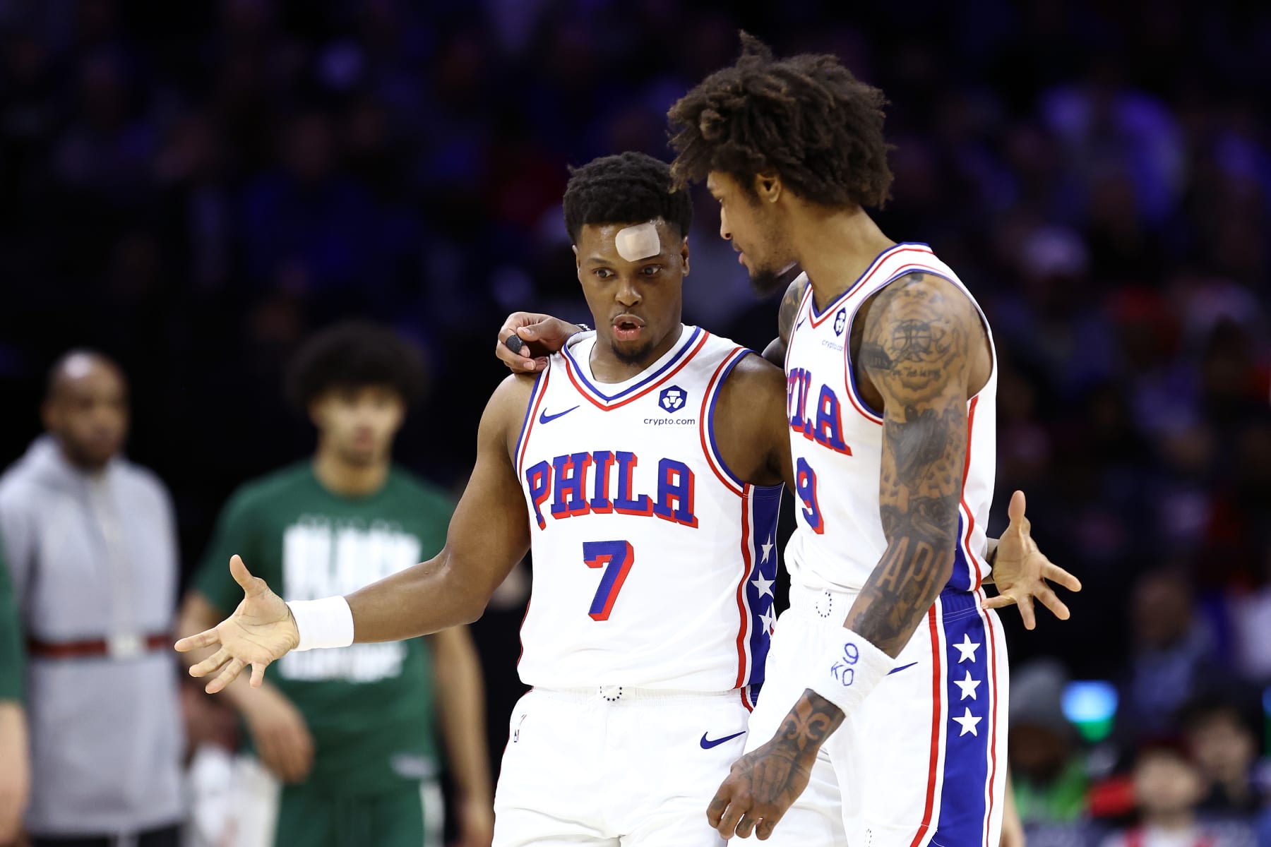 PHILADELPHIA, PENNSYLVANIA - FEBRUARY 25: Kyle Lowry #7 and Kelly Oubre Jr. #9 of the Philadelphia 76ers speak during the third quarter against the Milwaukee Bucks at the Wells Fargo Center on February 25, 2024 in Philadelphia, Pennsylvania. (Photo by Tim Nwachukwu/Getty Images)