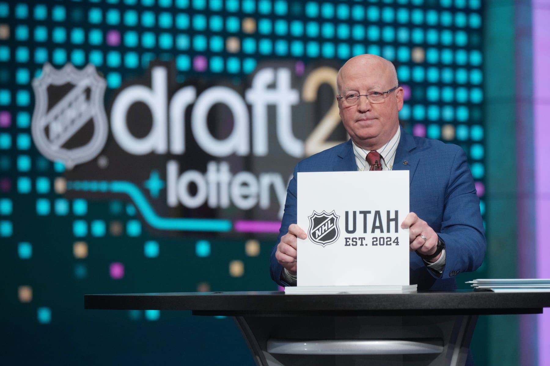 SECAUCUS, NEW JERSEY - MAY 07: National Hockey League Deputy Commissioner Bill Daly announces the Utah Hockey Club #6 overall draft position during the 2024 NHL Draft Lottery at NHL Network Studio on May 07, 2024 in Secaucus, New Jersey.  (Photo by Mike Stobe/NHLI via Getty Images)