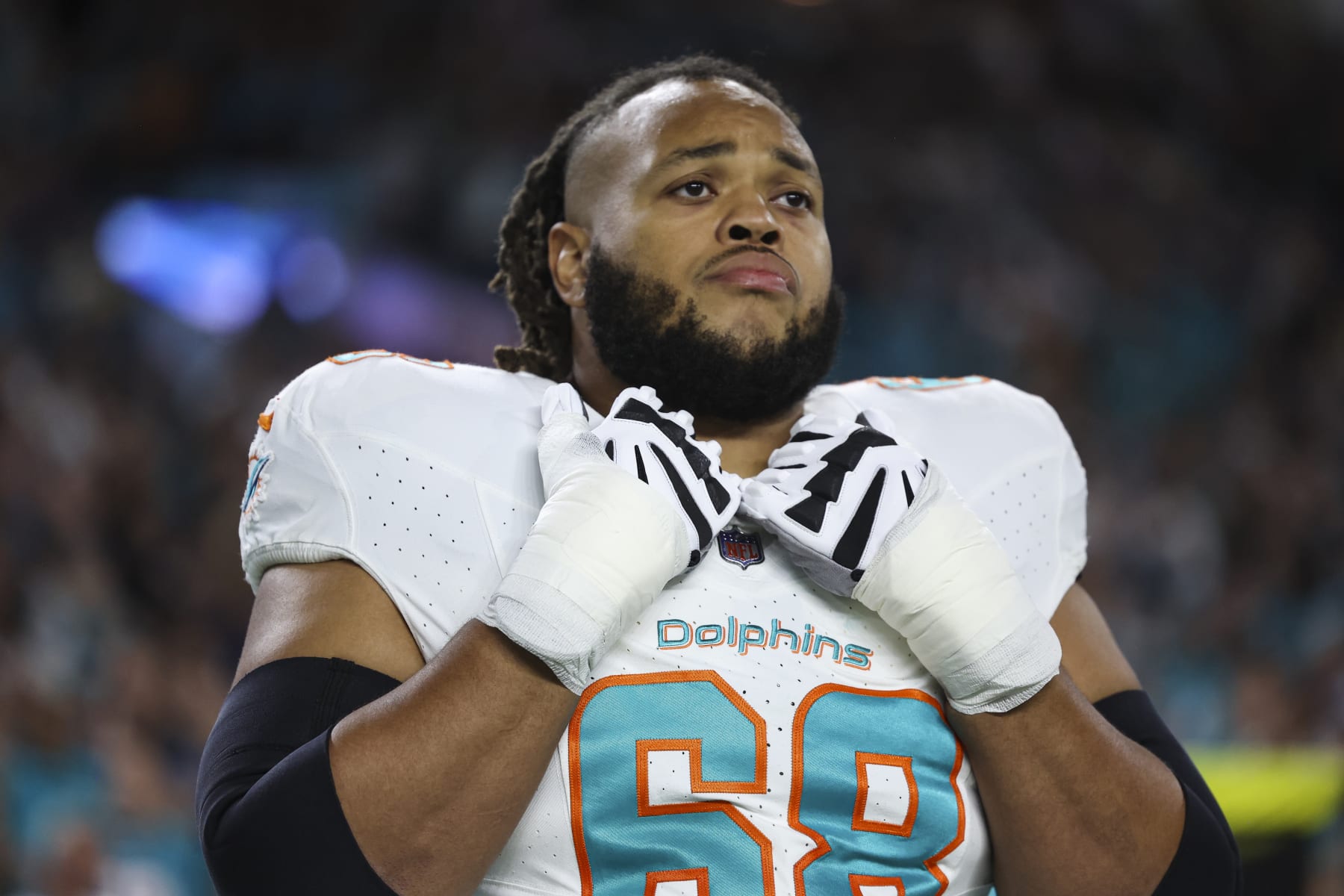 MIAMI GARDENS, FL - JANUARY 07: Robert Hunt #68 of the Miami Dolphins looks on from the sideline during the national anthem prior to an NFL football game against the Buffalo Bills at Hard Rock Stadium on January 7, 2024 in Miami Gardens, Florida. (Photo by Perry Knotts/Getty Images)