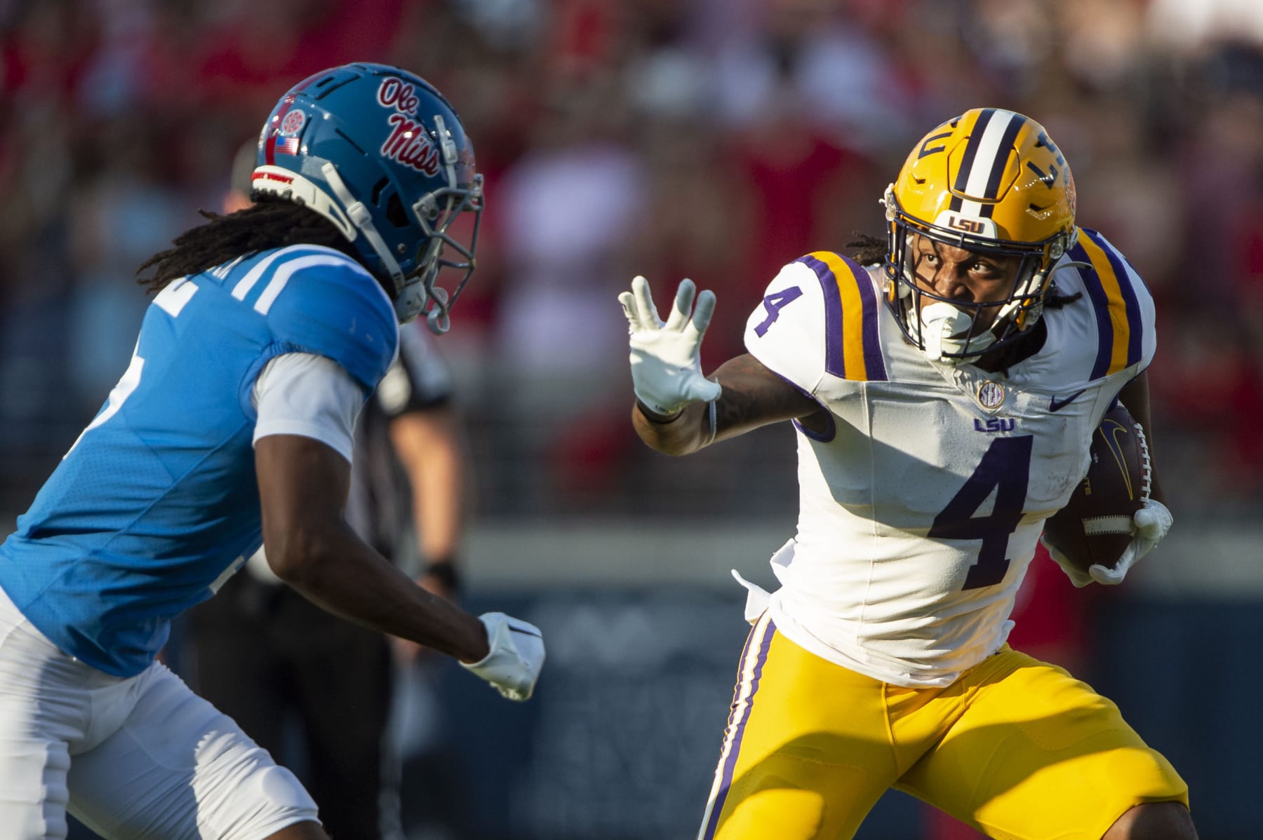 OXFORD, MISSISSIPPI - SEPTEMBER 30: Running back John Emery Jr. #4 of the LSU Tigers looks to run the ball by safety John Saunders Jr. #5 of the Mississippi Rebels at Vaught-Hemingway Stadium on September 30, 2023 in Oxford, Mississippi. (Photo by Michael Chang/Getty Images)