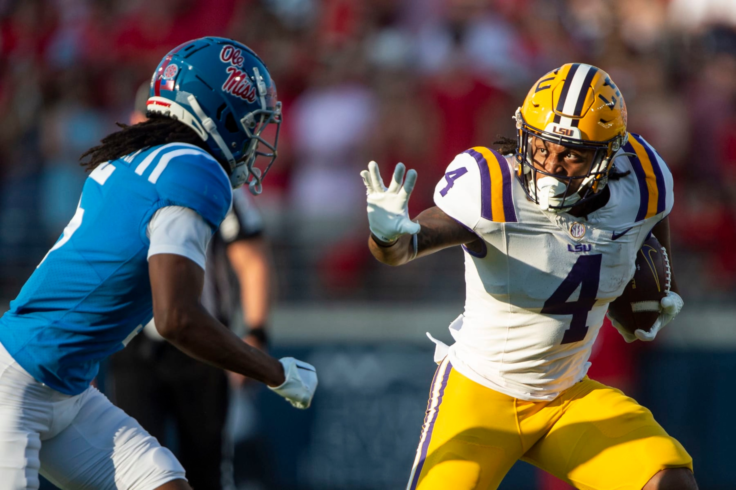 OXFORD, MISSISSIPPI - SEPTEMBER 30: Running back John Emery Jr. #4 of the LSU Tigers looks to run the ball by safety John Saunders Jr. #5 of the Mississippi Rebels at Vaught-Hemingway Stadium on September 30, 2023 in Oxford, Mississippi. (Photo by Michael Chang/Getty Images)
