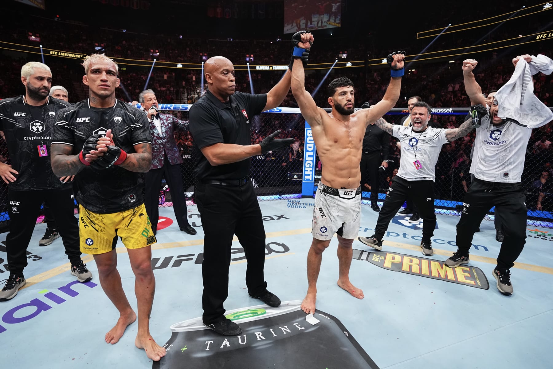 Arman Tsarukyan has his hand raised against Charles Oliveira