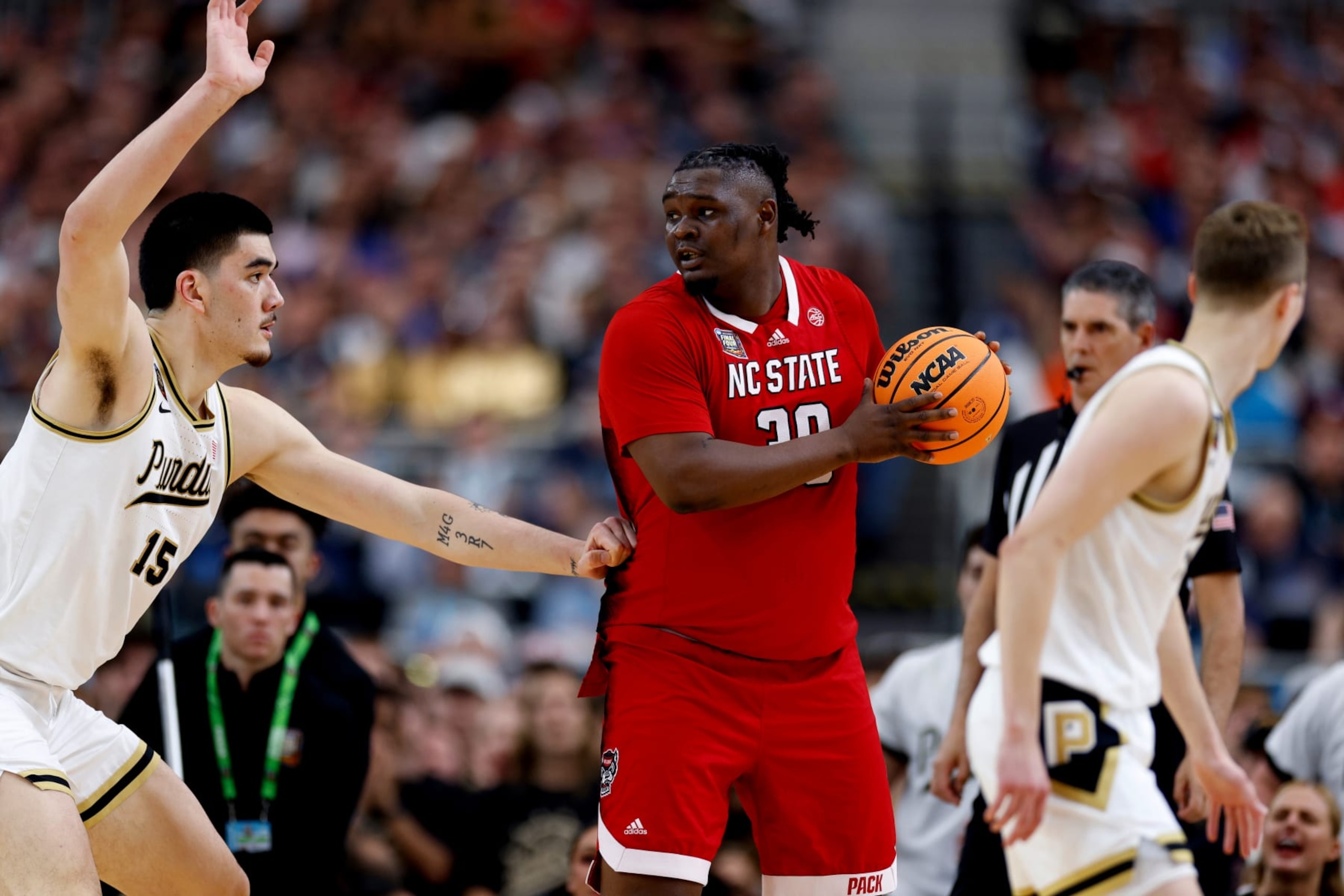 GLENDALE, ARIZONA - APRIL 06: DJ Burns Jr. #30 of the NC State Wolfpack checks his options against Zach Edey #15 of the Purdue Boilermakers during the first half in the NCAA Men's Basketball Tournament Final Four semifinal game at State Farm Stadium on April 6, 2024 in Glendale, Arizona. (Photo by Lance King/Getty Images)