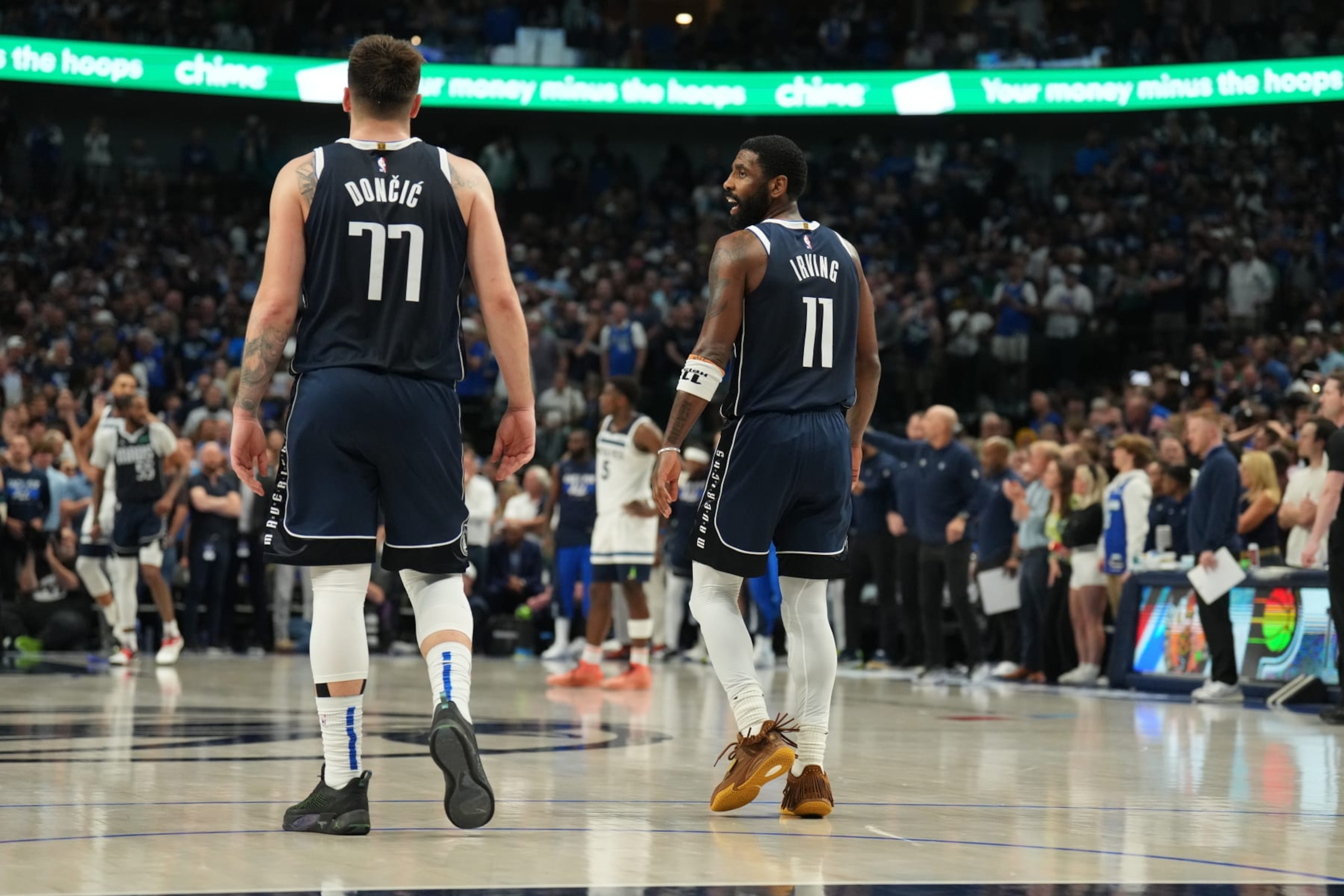DALLAS, TX - MAY 26: Kyrie Irving #11 and Luka Doncic #77 of the Dallas Mavericks celebrate after the game against the Minnesota Timberwolves during Game 3 of the Western Conference Finals of the 2024 NBA Playoffs on May 26, 2024 at the American Airlines Center in Dallas, Texas. NOTE TO USER: User expressly acknowledges and agrees that, by downloading and or using this photograph, User is consenting to the terms and conditions of the Getty Images License Agreement. Mandatory Copyright Notice: Copyright 2024 NBAE (Photo by Jesse D. Garrabrant/NBAE via Getty Images)