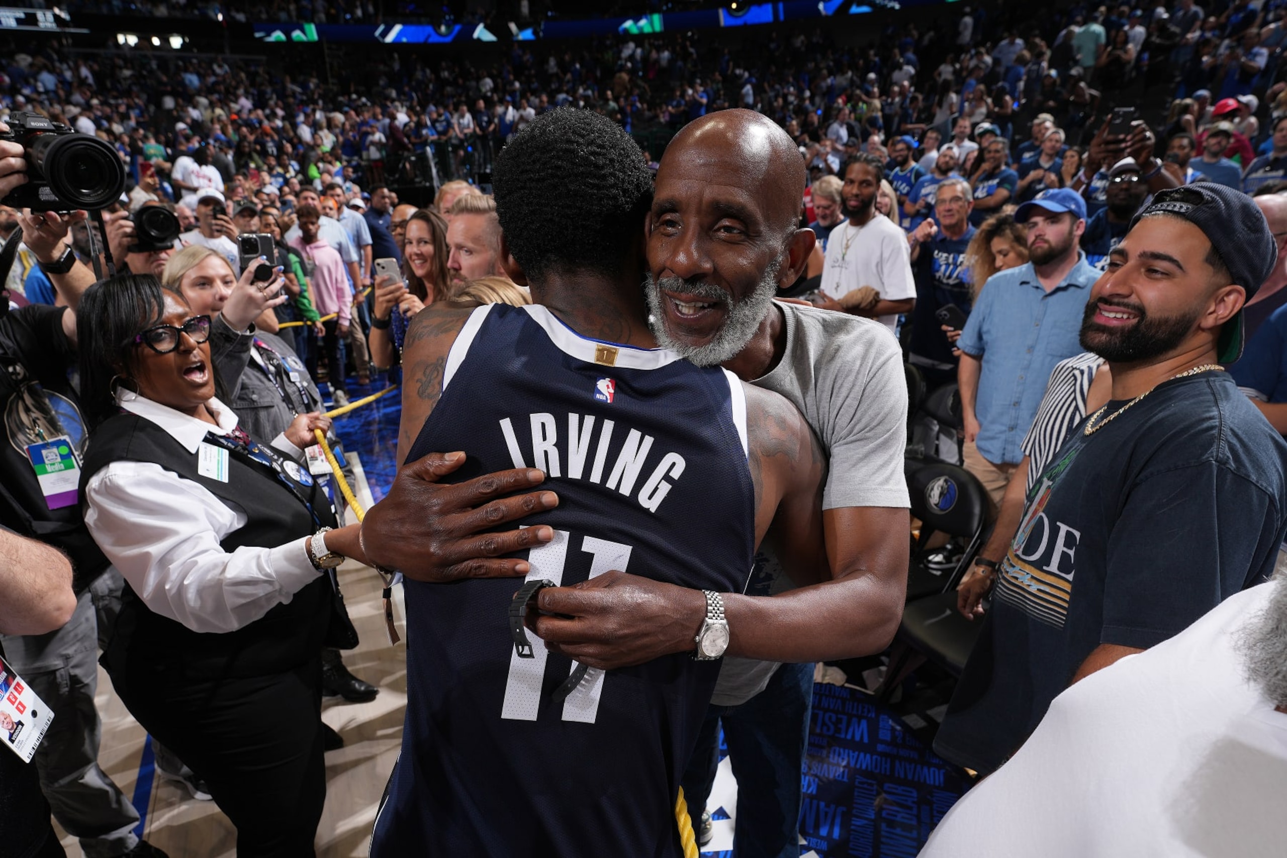 DALLAS, TX - MAY 26: Kyrie Irving #11 of the Dallas Mavericks greets his father, Drederick Irving after the game  against the Minnesota Timberwolves during Game 3 of the Western Conference Finals of the 2024 NBA Playoffs on May 26, 2024 at the American Airlines Center in Dallas, Texas. NOTE TO USER: User expressly acknowledges and agrees that, by downloading and or using this photograph, User is consenting to the terms and conditions of the Getty Images License Agreement. Mandatory Copyright Notice: Copyright 2024 NBAE (Photo by Jesse D. Garrabrant/NBAE via Getty Images)