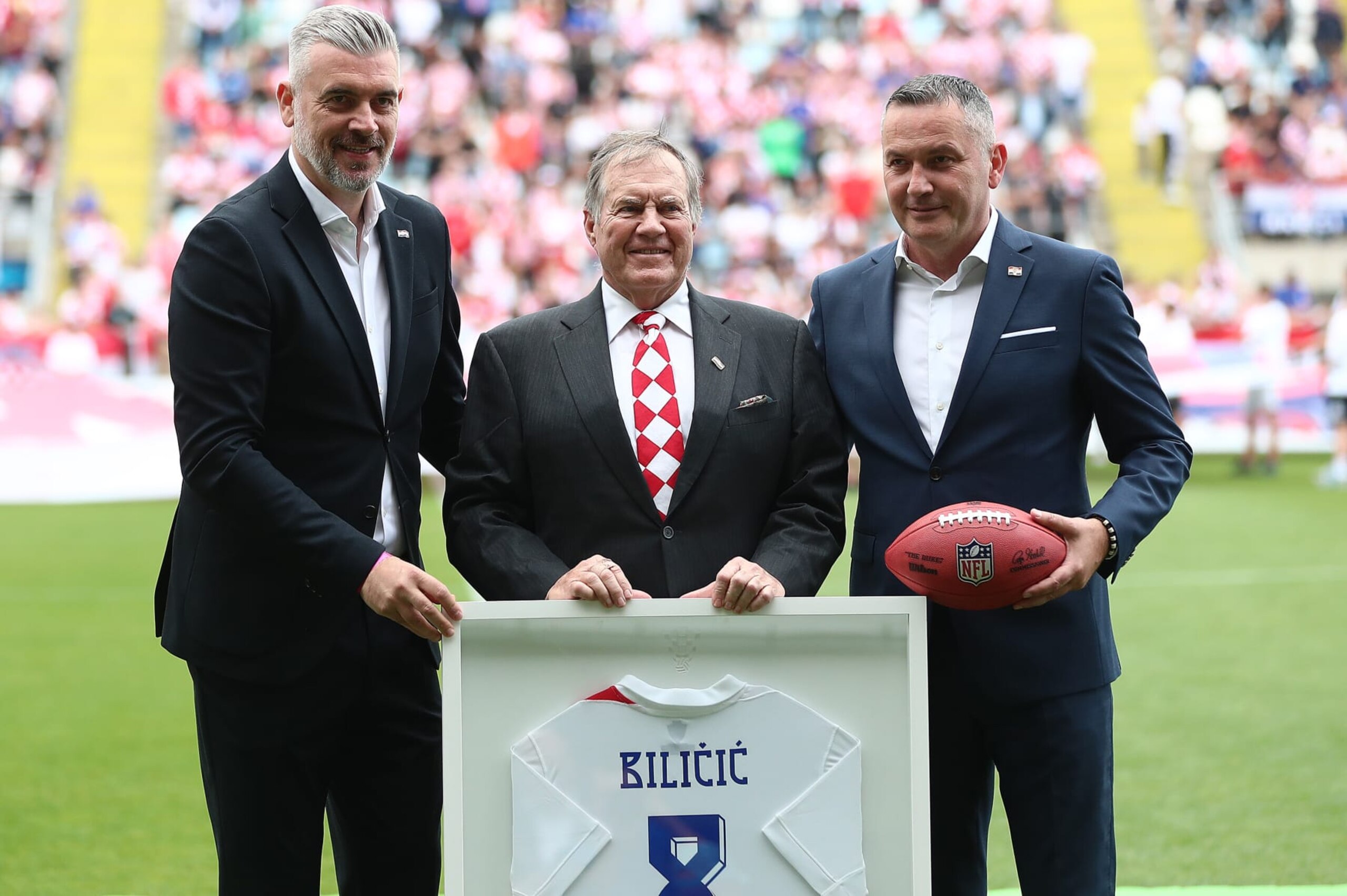 RIJEKA, CROATIA - JUNE 3: American football coach with Croatian origin Bill Belichick (C) who won eight Super Bowl titles gave Croatian Football Federation a NFL ball, while CFF gave him the jersey  at an International Friendly match between Croatia and North Macedonia at Stadion HNK Rijeka on June 3, 2024 in Rijeka, Croatia.  (Photo by Matija Habljak/Pixsell/MB Media/Getty Images)