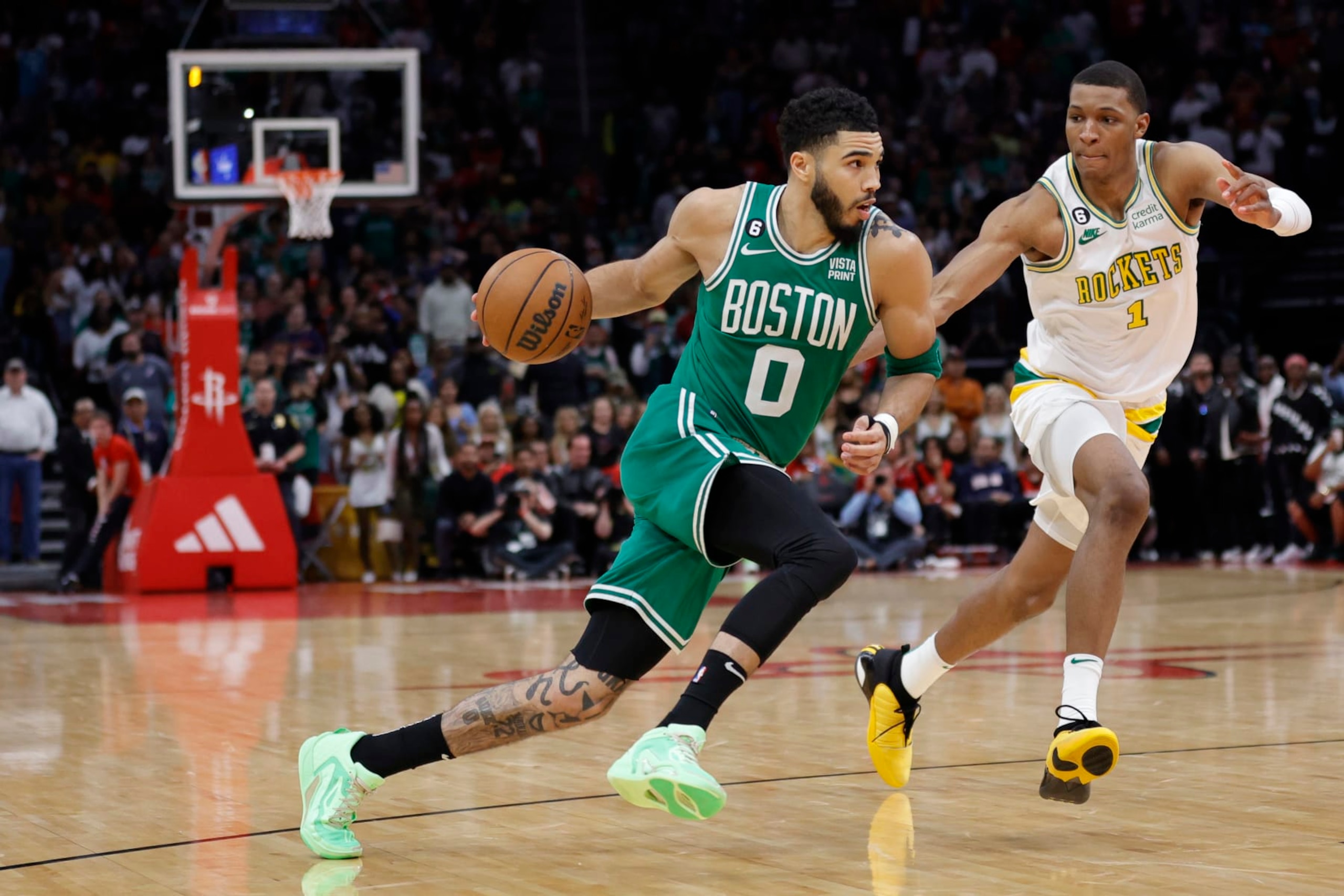 HOUSTON, TEXAS - MARCH 13: Jayson Tatum #0 of the Boston Celtics drives to the net ahead of Jabari Smith Jr. #1 of the Houston Rockets during the second half at Toyota Center on March 13, 2023 in Houston, Texas. NOTE TO USER: User expressly acknowledges and agrees that, by downloading and or using this photograph, User is consenting to the terms and conditions of the Getty Images License Agreement. (Photo by Carmen Mandato/Getty Images)